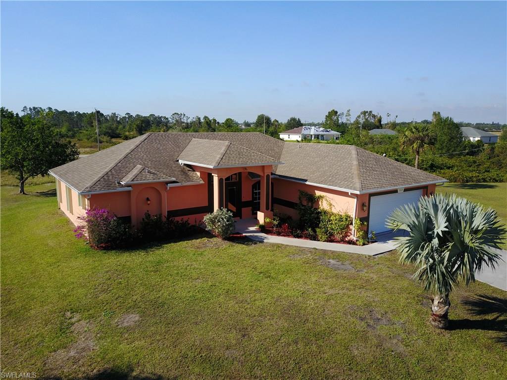 You are looking at the cream of the crop! This 2007 built home has been very lightly used as a vacation home and never as a rental. The light and airy airy floorpan features skylights, vaulted ceilings, plant shelves, tile flooring throughout, bullnose corners, stainless steel appliances, corian countertops, dual entry front door and so much more! The master bathroom features dual sinks, a walk in shower and walk in closets. The guest bathroom has an exterior access door which would be perfect use for a pool bath in the future! The rear lanai has pocket sliders that are perfect for entertaining and a large open lanai that is ideal for holiday barbecues! There is a big electric hurricane shutter covering the rear screened lanai, accordion shutters on the sides and the front has impact windows. The home is monitored with an ADT security system, the sprinkler system is only 4 years old, there are gutters installed and the exterior was completely repainted in March of 2017. The best feature of all? The owners have submitted an application with the county to combine both of the surrounding lots to make a huge .68 of an acre! Call today before someone snatches this one up!