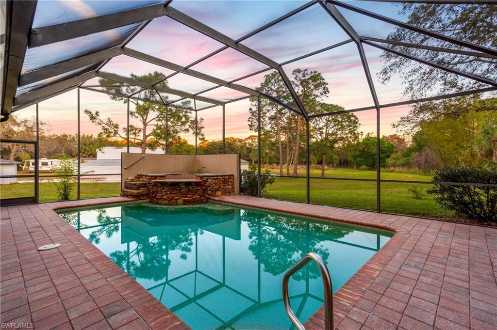 4 ACRES, 3 PROPERTIES, A 4,000 SQ FT WORKSHED, NO HOA, Zoned EQUESTRIAN/AGRICULTURE, and a DEVELOPER/INVESTMENT OPPORTUNITY! Discover a rare opportunity in the heart of Bonita Springs, an expansive 4 acre estate featuring 3 complete residences( 2 of the 3 properties are income producing for immediate cash flow), a resort-style pool retreat, and a 4,000 sq.ft. workshop, all just minutes from the sandy shores of Bonita Beach. The main residence at 28056 Eastbrook Dr. offers 4 bedrooms and 3.5 bathrooms, highlighted by a private screened-in pool with a waterfall spa, creating a sanctuary for relaxation and entertaining. The second home at 11203 Butler Dr. adds exceptional versatility with 3 bedrooms, 2 bathrooms, a bright sunroom, and an inviting jacuzzi tub. The third home is 28056 West Brook Dr which is 3 bed/3bath home over 2500 sq ft. Enjoy exceptional privacy paired with immediate access to I-75, shopping, dining, and all the conveniences of Bonita Springs, while the expansive workshop offers endless possibilities for hobbies, storage, equestrian/agriculture, or business use. Opportunities like this are rare! Schedule your private tour today and experience the space, flexibility, and lifestyle this exceptional estate provides.