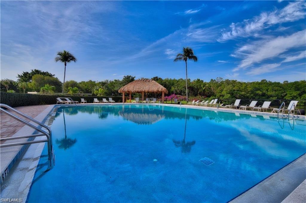 C4086.  Grab your beach chair and head to the white sands of Vanderbilt Beach and Wiggins Pass, both within 5-minute walk!  Turnkey furnished condo, cheerful end-unit 2 Bedroom, 2 bath with open floor plan.  Split bedrooms for privacy.  Hurricane shutters.  Beautifully maintained building with pool, grill, and clubhouse.