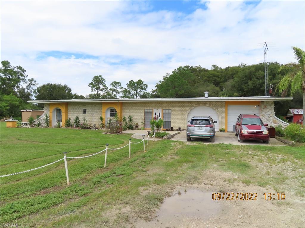 SELLER IS MOTIVATED TO SELL!!!! Unique rare steel construction home on beautiful 3.10 +/- acres outside city limits of LaBelle and off SR 29 S.   Home is 2,593 sq ft living area, open concept living area with electric fire place, large and spacious kitchen with plenty of cabinets, oversized bedrooms with large closets and a large garage with plenty of storage space.  Home also has a large screened pool for the HOT Florida weather and plenty of space for entertaining.  Outside features large steel workshop and an island in the middle of a pond as you enter the property. (Gazebo on island, but will need to be redone)  New owners could add their personal touches with some updates and make it their forever home,  secluded from all the hustle and bustle of city life.  You will not be disappointed!