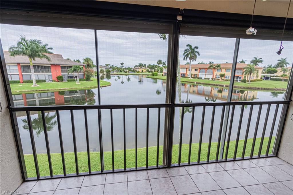 Here's the home you've been waiting for.  This gorgeous and well maintained 2 bedroom/2 bath condo features a light and bright eat in kitchen with lots of cabinet space, lower cabinets with pull out shelving, nice appliances, quartz-look low maintenance corian countertops, glass tile backsplash in kitchen and on breakfast bar.  The open living room offers vinyl flooring, a wet bar and a large upgraded fan.  The spacious master bedroom offers a gorgeous view, room darkening shades and a large walk in closet with mirrored door.  For the piece de resistance...picture yourself on quiet evenings sitting on the screened and tiled lanai, with it's coveted Western Exposure, overlooking the serene long lake view and watching Naples Majestic sunsets.  It just doesn't get better than that...but wait...the lanai also has a retractable sun shade AND electric hurricane shutters.  All other windows have roll down manual shutters.  All of this and it's located close to 41 and downtown shops, restaurants and gorgeous beaches.  You don't want to miss this one.