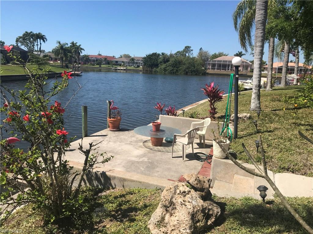 Peaceful Waterfront Home! Water views from 6 different rooms. Fabulous Intersecting wide canal views with access to Lake Manitoba and many other canal routes. Bring your boats, fishing poles and participate in the many bass tournaments held in this canal. City water and sewer assessment paid in full. What more can you ask for? Vaulted ceilings in every room. Recently painted inside and out. New roof in 2004, repiped in 2005, new heating and air 2010, updated kitchen and bathrooms, all new stainless steel appliances (2016), new heat and A/C unit in August 2010. Tile floors throughout including the large oversized enclosed FLORIDA ROOM with vinyl windows making it another 418 sq. ft. room, for a total of 1862 sq. ft. under roof. Enjoy them opened or closed. 2 car garage has a huge built-in work table with overhead light. Not in a flood zone. Newly landscaped, with tropical plants, plumeria, orange, lemon, and tangerine trees. The concrete dock will accommodate your boats. Plenty of room for a pool. Wind mitigation done, saving 50% on insurance. (transferable, expires 7/18 )