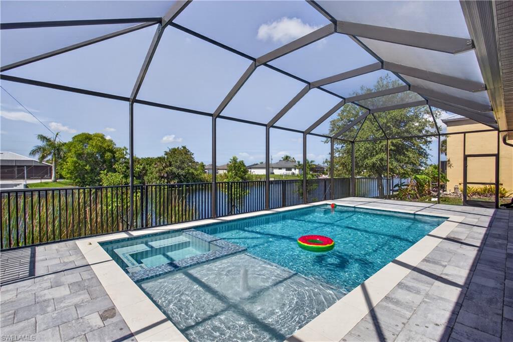 REFINED WATERFRONT LIVING in SHADROE CANAL! MOVE-IN-READY 2026 COASTAL CONTEMPORARY NEW CONSTRUCTION w/ 2-10 HOME WARRANTY & SOUTHERN rear exposure for all-day SUNSHINE! Enjoy poolside living w/ 115 feet wide FRESHWATER CANAL VIEWS, perfect for KAYAKING, PADDLEBOARDING, JET SKIING & small boat ADVENTURES! Located in SW Cape Coral, durable METAL ROOF, 3-CAR GARAGE & CITY WATER & SEWER! $1,800-$2,400/year homeowners' insurance! Enjoy easy access to BURNT STORE RD & PINE ISLAND RD, your commuting & daily errands easier! This CONTEMPORARY LUXURY HOME features SCREENED, HEATED POOL & SPA & 4 BEDS (2 primary suites) & 3 full BATHS, layout is ideal for EVERYDAY LIVING & ENTERTAINING! SCREENED LANAI w/ PERFECT SETTING TO RELAX in SPA, SWIM in HEATED POOL, or HOST UNFORGETTABLE BBQs! Bright, open layout w/ LIGHT NEUTRAL TILE FLOORING. IMPACT-RESISTANT DOUBLE DOORS lead into WELCOMING LIVING ROOM w/ 14-ft VOLUME CEILING & SLIDING DOORS TO LANAI. GORGEOUS CHEF’S KITCHEN w/ sophisticated CUSTOM CABINETRY w/ warm NATURAL WOOD-GRAIN base cabinetry paired w/ elegant LIGHT GREIGE FLAT-PANEL UPPER CABINETS. Rich EUROPEAN OAK-INSPIRED wood texture add warmth & dimension. Crisp QUARTZ COUNTERTOPS & FULL-HEIGHT QUARTZ BACKSPLASH w/ clean modern palette, while UNDER-CABINET LED LIGHTING enhances bright, open ambiance. Equipped w/ SS appliances, French-door refrigerator, microwave, smooth-top range, cabinetry covered HOOD & dishwasher. Oversized WATERFALL ISLAND w/ striking vertical WOOD SLAT DETAILING, abundant storage & minimalist HARDWARE-FREE CABINETRY. Built-in BUTLER’S PANTRY showcases matching WOOD-GRAIN BASE CABINETRY, sleek LIGHT GREIGE UPPER CABINETS, QUARTZ countertops, under-cabinet lighting & built-in WINE REFRIGERATOR, creating the perfect BEVERAGE STATION, COFFEE BAR, or EXTRA STORAGE & PREP SPACE. DINING ROOM features a soaring volume ceiling, recessed LED lighting & LARGE PICTURE WINDOW to screened lanai, pool/spa & waterfront. LARGE PRIMARY SUITE w/ sliding doors to lanai, WALK-IN CLOSET w/ BUILT-IN SHELVING & HANGING RACKS & LUXURIOUS PRIMARY BATHROOM w/ spacious WALK-IN GLASS SHOWER w/ floor-to-ceiling designer tile, rainfall showerhead, built-in bench & modern matte-black fixtures. Dual sink vanity w/ quartz countertops, sleek white cabinetry & contemporary lighting complements the spa-like design. Private water closet & natural light create BRIGHT & SERENE RETREAT! BUILT-IN CUSTOM CLOSET WHITE CABINETRY for ADDED STORAGE & CLEAN, UPSCALE LOOK. SPLIT LAYOUT w/ SECOND PRIMARY SUITE w/ POOL BATHROOM & TWO GUEST BEDROOMS w/ HALL BATHROOM for added privacy. Step outside to SCREENED LANAI w/ HEATED POOL & SPA, landscape, SEAWALL & FULLY EQUIPED OUTDOOR KITCHEN w/ BUILT-IN stainless steel BBQ GRILL, SINK, BEVERAGE REFRIGERATOR, GRANITE COUNTERTOPS & MODERN BACKSPLASH! PAVER FLOORING & CEILING FAN create COMFORTABLE SPACE. LAUNDRY, 3-CAR GARAGE & long-lasting METAL ROOF complete HOMES' FUNCTIONAL FEATURES. LUXURY FRESHWATER WATERFRONT LIVING STARTS HERE!