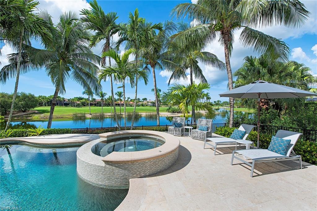 This exceptional lakefront estate has recently undergone an extensive renovation and is located in the prestigious Isle Toscano neighborhood of Grey Oaks. Elegant luxury surrounds you throughout this expansive five bedroom, five full and three half bath home including all new light porcelain flooring in the main living areas, stylishly updated kitchen and bathrooms and newly expanded pool deck with linear fireplace. This custom-designed plan offers expansive long range lake and golf course views from nearly every room in the home. Entertain friends and family with the state-of-the-art home theatre including 12 motorized reclining chairs, game room, chef's kitchen, butler's pantry and walk-in wine cellar. The elegant master suite boasts a gas fireplace, sitting area, two walk-in closets, stunning bath with all new tile and free standing soaking tub and walk-thru shower. Additional features include impact-resistant windows and doors, custom parquet floor in study and master bedroom, private exercise studio, rare Santos mahogany hardwood floors on the second level, spacious guest suites with updated baths, multi-level pool with swim up bar, spa and water features.