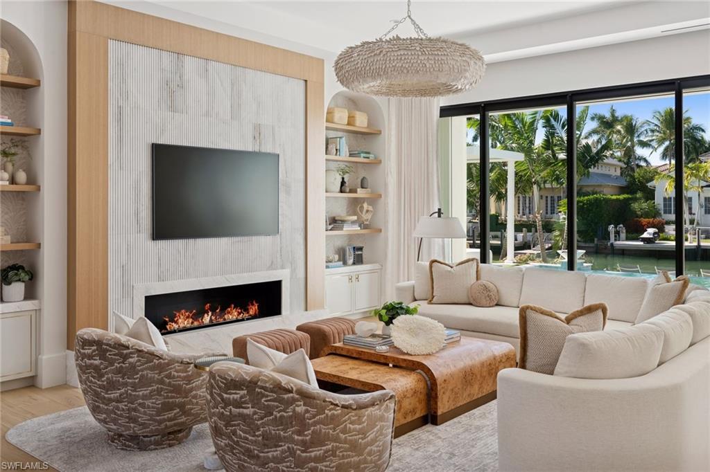 This is the one you have been waiting for. A rare, custom built new construction residence showcasing timeless features and bespoke finishes, set within the highly sought-after Aqualane Shores, one of Naples’ most prestigious enclaves.
 
Highlights include a first-floor primary wing with a spa inspired bath, an inviting waterside lounge and bar, and extraordinary outdoor living spaces overlooking wide western exposure canal views. Designed by the celebrated team at Amy Storm and Company, envisioned by renowned architect Jon Kukk, and expertly executed by C&E Builders, this luxury residence exudes effortless sophistication. Natural materials and serene, layered neutral tones are thoughtfully integrated throughout, creating a timeless aesthetic that complements any design style.
 
An elevator provides seamless access to every level, enhancing everyday living. Inside, bright and airy interiors are complemented by wide plank white oak floors, adding warmth and refined elegance throughout. The gourmet kitchen is a chef’s dream, showcasing a custom stone hood, a La Cornue range, top-tier appliances, and a butler’s pantry.
Step outside to your private oasis, where an expansive lanai is designed for entertaining and features a fully equipped outdoor kitchen, fireplace, and generous gathering space. Relax by the sparkling pool and spa, unwind beneath the pergola with a daybed, or gather around the fire pit under the stars - creating an inviting setting for memorable evenings.
For tech enthusiasts, the home is equipped with a state-of-the-art, high end AV system that delivers an immersive entertainment experience throughout the residence. Boaters will appreciate the direct Gulf access, making this a true waterfront retreat. Ideally located just moments from Naples’ pristine beaches, along with the world-class shopping and dining of 3rd Street South and 5th Avenue South, this home offers the perfect balance of luxury, convenience, and serene coastal living. This exceptional residence must be seen to be truly appreciated.
