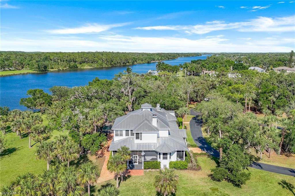 Alva Equestrian 30 Acre River Ranch in Southern Olde Florida design. This is a custom-built two-story Riverfront equestrian masterpiece.  The Main house features 4 elegantly designed bedrooms and 5 bathrooms. The home has over 5,000 square feet of living area in the main house and 9,000 square feet of total area. The main residence includes a large open eat-in kitchen with butcher block island, double ovens, travertine tile backsplash, granite countertops, large windows and French doors that deliver scenic River views from nearly every room. The family room, with wood burning fireplace,  features expansive picture windows which maximize the panoramic river view from nearly every angle. The home is paired with beautiful hardwood floors and natural stone travertine throughout. The primary bedroom suite is drenched in sunlight coming in from wall-to-wall windows along the open-style solarium sitting room. More than a house ~ this is a home.

Lounge on the Southern-style wrap around porch or relax by the pool and jacuzzi. Stroll down the  brick walkway to the  boat dock situated along the Hickey’s Creek natural inlet.  Enjoy the boat & yachts cruising down the intracoastal while sitting by the custom built fire pit just feet from the water’s edge. Visit the equestrian facility & have coffee in the barn house while feeding the horses. The 8 stalls & the AC tack room give you ample room to run the barn business.

Trail ride under the shade of Spanish moss covered oaks and Florida palm trees on 15 Acres of equestrian trails. The barn, post and beam construction, is outfitted with air conditioned tack room, and one bedroom/one bath living quarters above.

The property is located 20 minutes from Downtown Ft Myers in the quaint community of Alva, population 3,000, rich with the best of Southern history and traditions. Located one mile east of the Franklin Lock State Park with direct deep-water boating access from East Coast or West Coast. Yacht harborage/dock will accommodate a 100 ft vessel. 
25-43-26-00-00009.0010
24-43-26-L3-00005.0000
24-43-26-L3-00000.000A
24-43-26-L3-00003.000B
24-43-26-00-00003.000C
24-43-26-L3-00003.000D
24-43-26-L3-00003.000E
24-43-26-L3-U3362.5516
24-43-26-L3-U3361.5519

Retreat to this picturesque peaceful enclave that offers the best that SWFL has to offer. River & Ranch includes boating & equestrian for everyone. Look no more: THIS IS IT !
NEW METAL ROOF 2025 The Best Riverfront Value in Lee County