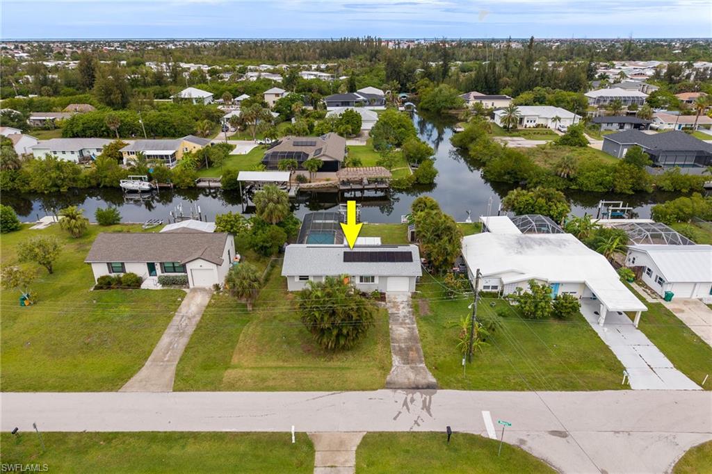 Waterfront living awaits in this lovely 2-bedroom, 2-bathroom pool home in a desirable Tierra Coronado neighborhood! Situated on a Gulf access intersecting canal, this property offers beautiful water views, quick boating access, and the ultimate Southwest Florida lifestyle. Inside, the home offers a comfortable and functional layout with plenty of natural light and tile flooring throughout. The beautiful kitchen has been updated with white shaker style cabinetry, quartz countertops, stainless steel appliances including a new range and dishwasher, while the new washer and dryer add convenience and value. The home features a primary suite with a private en suite bathroom and convenient step-in shower, along with a guest bedroom offering easy access to the hall bathroom with a tub/shower combination. Enjoy your private backyard oasis featuring a sparkling pool with a new pool heater and a paver patio, perfect for year-round enjoyment. The fenced backyard offers a safe and spacious area for kids and pets to play, while the garden shed provides convenient extra storage for tools and outdoor equipment. Boaters will appreciate the boat dock with lift, making it easy to spend your days exploring Charlotte Harbor and the Gulf waters beyond. Energy-efficient solar panels help reduce utility expenses year-round. Whether you're looking for a seasonal retreat, full-time residence, or investment opportunity, this waterfront gem combines comfort, convenience, and exceptional canal-front living in a quaint Punta Gorda boating community. Conveniently located just minutes from Fisherman's Village, Punta Gorda airport, as well as a variety of restaurants, shopping, and local attractions. Don't miss your chance to enjoy Florida living at its finest!