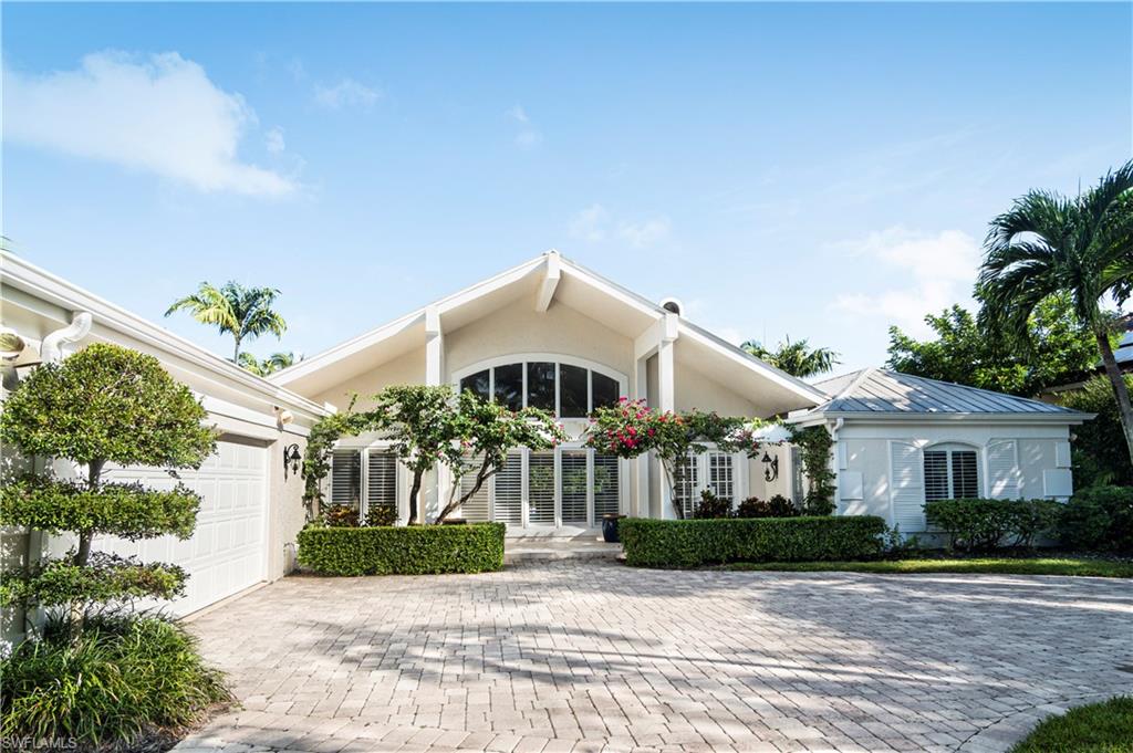 Aqualane waterfront home of casual elegance.  Exquisite for boating, beaching and strolling through historic Third Street for dining and shopping. Boat dock with lift. Summer kitchen with spectacular firepit on the dock for cozy, seasonal evenings.  Open floor plan with four private ensuites, living and family room accented by an inviting fireplace. Large sliding glass doors open to lanai and pool area and offer tons of light inside. Great entertaining home.