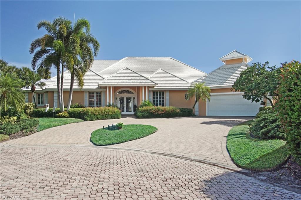 Lovely lakefront home situated in Waterford, an exclusive enclave of estate homes. Exterior features include an extra large lot on a quiet cul-de-sac, lush landscape, circular paved drive, large pool with seperate spa, and storm protection. Interior features include a bright and open floor plan, wood flooring, tile, two offices, wet bar,  spacious en suite bedrooms, volume ceilings and tons of storage. This home is perfect for indoor and outdoor entertaining. The open floorplan flows directly out to the expansive outdoor pool area with under roof protection and built in grill area. Pelican Bay amenities include miles of walking paths, fitness center, spa, tennis, pickle ball (coming soon), private golf, canoes and kayaks for resident use, three miles of beachfront with private restaurants and pavilions. Centrally located between the Ritz Carlton Beach Resort and upscale Waterside Shops and Restaurants. This is the ultimate in Florida living.