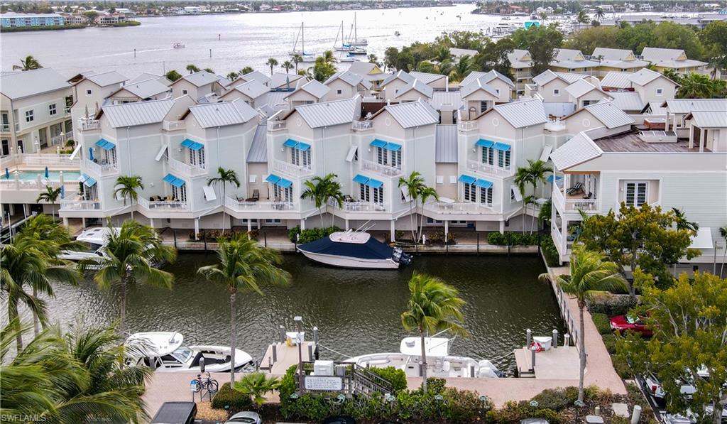Experience the allure of waterfront living in the highly desirable Olde Naples Seaport area. This fully furnished three-bedroom, three-bathroom residence is a true haven for boating enthusiasts. The open floor plan radiates elegance while fostering a relaxed lifestyle. A private elevator from the two-car garage provides direct access to your home, which is equipped with all the essential amenities for enjoying Naples, including a prime location. A bayside balcony off the living area enhances the overall ambiance, while a private rooftop patio awaits your personal touch, offering the perfect setting to conclude any day. The spacious layout is ideal for gatherings with family and friends, while the multi-level design ensures privacy when needed. The owners' suite is generously proportioned and boasts breathtaking views of the bay. Additional features include ample storage, a community pool, ground-level dockside walking paths on two sides, and plentiful guest parking. Beyond this exceptional location, the home offers convenient access to all that Naples has to offer: pristine sandy beaches, biking and walking trails, museums, performing arts venues, galleries, fine dining, and excellent shopping options.
