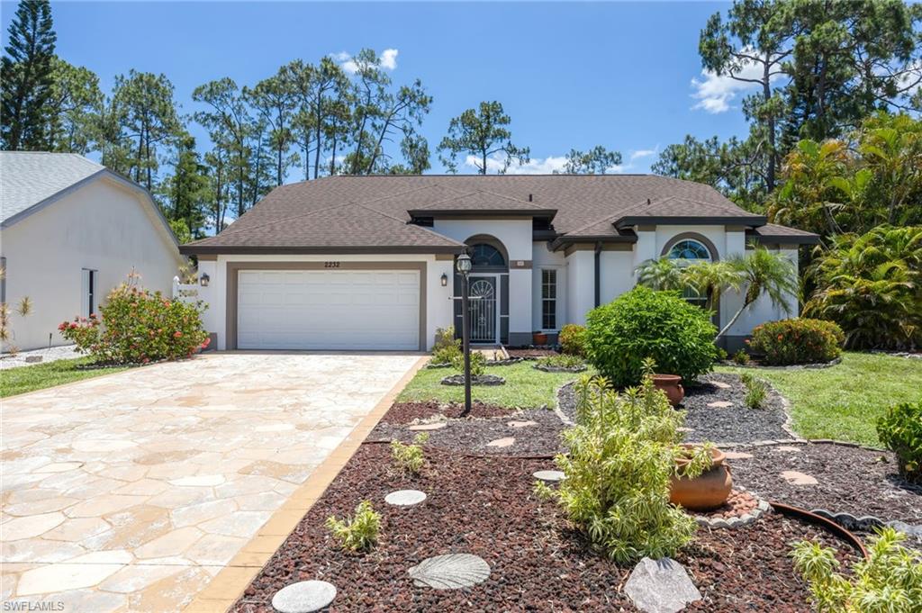 Welcome to this beautifully maintained 3 bedroom, 2 bath home with a 2 car garage in the highly desirable Crown Pointe community. Situated on a large private homesite with plenty of room for a future pool, this residence offers an inviting open floor plan. The spacious layout includes a sunlit breakfast room, formal dining area, and generous living room that seamlessly flow together. The kitchen features custom-crafted European-style white cabinetry, white appliances, and an open design overlooking the breakfast area. Tile flooring throughout the home adds both style and easy maintenance. The primary suite offers a peaceful retreat with access to the lanai, a large walk-in closet and an ensuite bath complete with dual sinks, soaking tub, separate shower, and a private water closet with an additional sink. The guest bathroom has been tastefully remodeled, providing updated finishes and functionality. Enjoy Florida living at its best from the extended screened lanai, featuring a covered seating area perfect for relaxing or outdoor dining, along with a generous sun deck ideal for soaking up the sunshine. Beyond the lanai, the oversized backyard provides a peaceful, private setting surrounded by nature. Additional features include impact-resistant windows, a new roof and front door installed in 2019. Residents of Crown Pointe enjoy exceptional amenities including two scenic lakes with park-like surroundings, a clubhouse, community pool, fitness center, sauna, tennis courts, and pickleball. Conveniently located less than five miles from Naples' world-famous white sand beaches and the shopping, dining, and entertainment of Fifth Avenue South and downtown Naples. One or more photos have been AI-generated or digitally modified. (Agents see confidential remarks.)