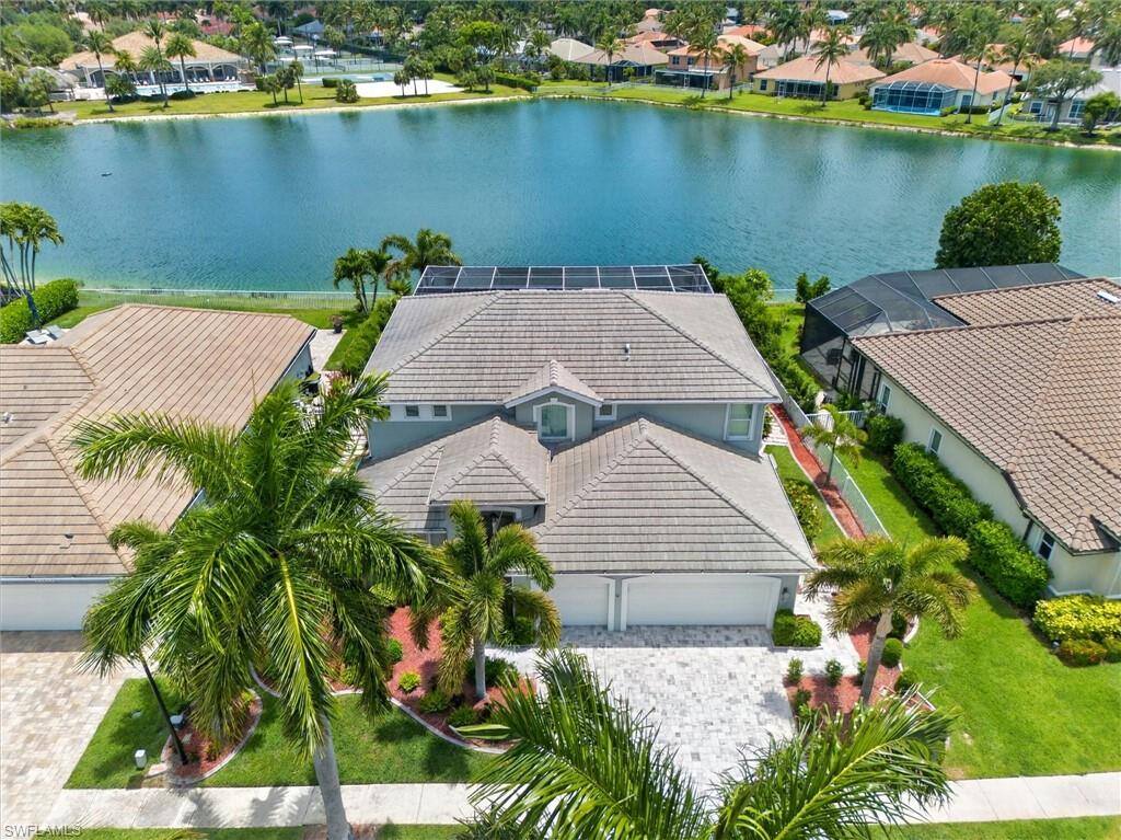 Welcome home to the highly sought-after gated community of Reflection Lakes! This spacious, fully remodeled two-story residence offers the perfect blend of comfort, style, and functionality with 4 bedrooms, 3 bathrooms, just under 3,500 square feet of living space, and a 3-car garage (with the third car currently being utilized as flexible bonus space that can easily be converted back). Step inside and be greeted by soaring ceilings and tile flooring throughout the main living areas. The beautifully remodeled chef’s kitchen is designed to impress, featuring quartz countertops, stainless steel appliances, decorative tile backsplash, a walk-in pantry, breakfast bar, and exceptional space for both everyday living and entertaining. This home offers the rare convenience of two owner’s suites. The first-floor primary suite serves as a private retreat with a spacious sitting area, built-in entertainment center, walk-in closet, and a luxurious remodeled en-suite bathroom complete with dual vanities and an oversized tiled walk-in shower with a rain shower head. Upstairs, you’ll find a versatile loft along with an additional owner’s suite featuring a private screened balcony overlooking the lake, a large walk-in closet, and a stunningly updated bathroom with dual vanities, a soaking tub, and a beautifully tiled walk-in shower with decorative stone accents. Step outside into your own private outdoor oasis designed for year-round enjoyment and entertaining. Take in the serene lake views while relaxing in the heated pool and spa, all enclosed within the picturesque screened lanai featuring paver decking and a covered seating area. Additional highlights include a newer tile roof (2018) and accordion/electric hurricane shutters for added peace of mind. Ideally located just minutes from the white sand beaches of Fort Myers, Sanibel, and Captiva, this home also provides convenient access to Southwest Florida’s premier shopping, dining, entertainment, and RSW International Airport. Reflection Lakes residents enjoy an active lifestyle with resort-style amenities including tennis, pickleball, a fitness center, and a community pool—all with low HOA fees. This exceptional property truly captures the best of Florida living. Schedule your private showing today!