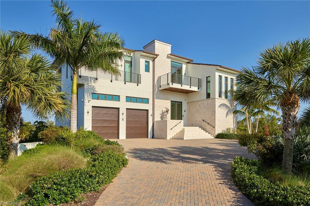 Incredible serene location in the heart of nature with envious views. Offering a backdrop of colorful sunrises, sunsets and panoramic views of bays/mangrove islands out to the Marco skyline. This 2017-built estate expresses the style and flair that hallmark the Southwest Florida lifestyle, elegant but casual barefoot-living while bringing the outdoors in. Taking advantage of the elevation, you will enjoy immense privacy and picturesque views from every room. Stunning architectural details throughout with cutting-edge technology. Offering 3,519 square feet, 2 floors, 3 bedrooms, 3.5 baths, walnut hardwood floors, impact glass, spacious lanai with spa, maintenance-free vacuum elevator, generator, 4-car garage, plus a boat/small RV garage. This home is fully automated with the latest Elan software; most everything in the home can be controlled from a phone or tablet. Located in the prestigious, gated community of Key Marco, where you can escape and get away from it all. Enjoy the community with fitness center, social room, tennis and optional boat slip with direct access to fishing, adventure and endless sightseeing among the 10,000 Islands and beyond.