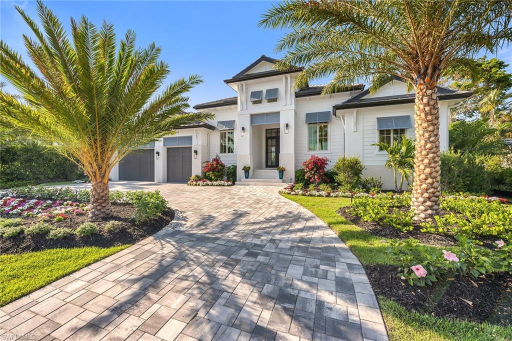 On one of the most desirable streets in Park Shore, this exquisite residence by Lutgert Custom Homes is the epitome of luxury. Boasting a refined coastal design aesthetic, the attention to detail is certain to impress even the most discerning buyer. Beautifully appointed finishes and selections by Soco Interiors abound. Expansive walls of glass allow for a seamless extension of luxury living space. The professionally designed landscaping creates the ideal canvas for the stunning resort-inspired outdoor living area. Complete with innumerable features including  saline pool and spa, loggia with summer kitchen and gas fireplace. This location could not be more ideal, with proximity to myriad shopping, dining and cultural offerings, as well as a private beach access and boat slips available for purchase exclusively for Park Shore residents.