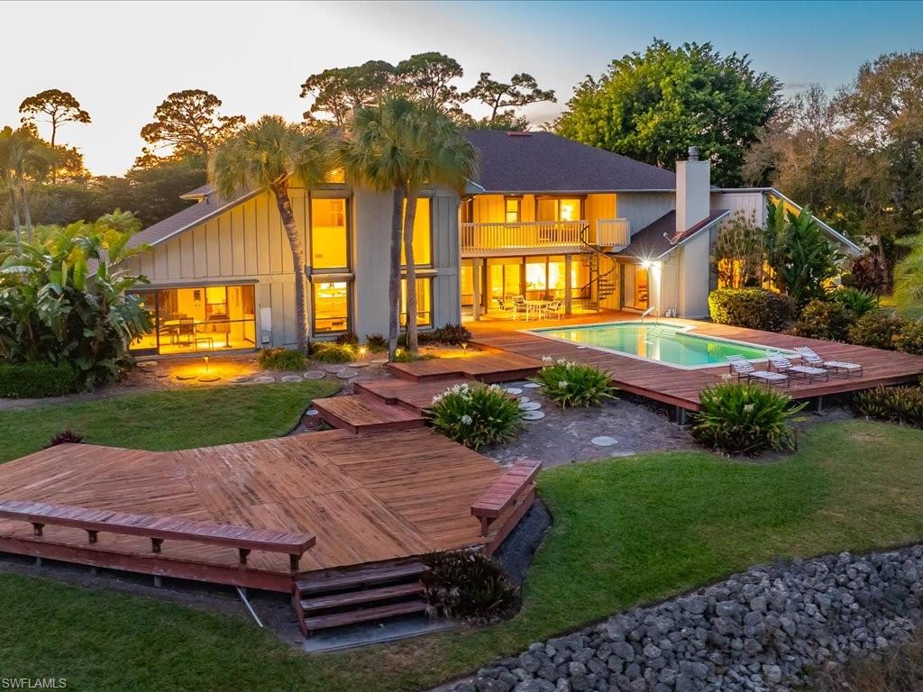Set behind a curtain of mature landscaping and shimmering water, 154 Cajeput Drive presents a rare and compelling opportunity to create a legacy estate within the heart of Pine Ridge Estates. Spanning nearly one point nine acres with more than two hundred feet of lake frontage, this secluded property captures the essence of refined Naples living defined by space, privacy, and natural beauty. The expansive lakefront setting serves as the home’s defining feature, offering long, tranquil water views and an exceptional sense of openness rarely found this close to the city’s most desirable destinations. Whether envisioned as a reimagined retreat or a site for new architectural expression, the generous acreage allows for sweeping outdoor living spaces designed to embrace the water and the surrounding tropical landscape. A private tennis court elevates the property into true estate territory, providing a resort-style amenity that complements an active yet elegant lifestyle. The presence of a separate guest house offers flexibility for hosting extended guests, accommodating staff, or creating a private studio or office, all while preserving the main residence’s sense of retreat. Seclusion is paramount here, with the home discreetly positioned to ensure privacy without sacrificing convenience. Pine Ridge Estates is renowned for its estate-sized parcels and proximity to Naples’ celebrated dining, shopping, and white-sand beaches, allowing residents to enjoy both tranquility and accessibility. 154 Cajeput Drive is a singular canvas for those seeking lakefront acreage, coveted amenities, and enduring value in one of Naples’ most prestigious communities. An exceptional opportunity to secure a private waterfront lifestyle and craft an estate that reflects your vision of elevated coastal living.