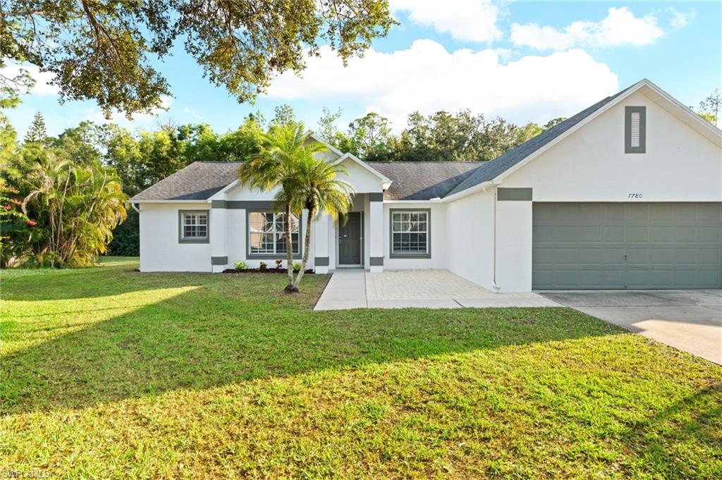 Charming 3-bedroom, 2-bath home nestled on a 0.29-acre lot in a quiet, well-kept cul-de-sac neighborhood. Enjoy a spacious feel throughout thanks to the volume ceilings and open-concept floor plan with modern tile floor throughout the house. The kitchen flows into the main living areas and features a large quartz countertop with bar seating, perfect for casual dining and entertaining. The split-bedroom layout offers privacy for family and guests alike. The primary suite includes a beautifully updated bathroom with a new double vanity, soaking tub, separate shower enclosure, and a walk-in closet. The second bathroom also features an updated vanity and a full bath. Step outside to your private, oversized screened patio overlooking the backyard—ideal for relaxing, playing, or entertaining. Located just minutes from shopping, dining, downtown Naples, and the area’s stunning beaches. With low HOA fees, this home truly has it all!
