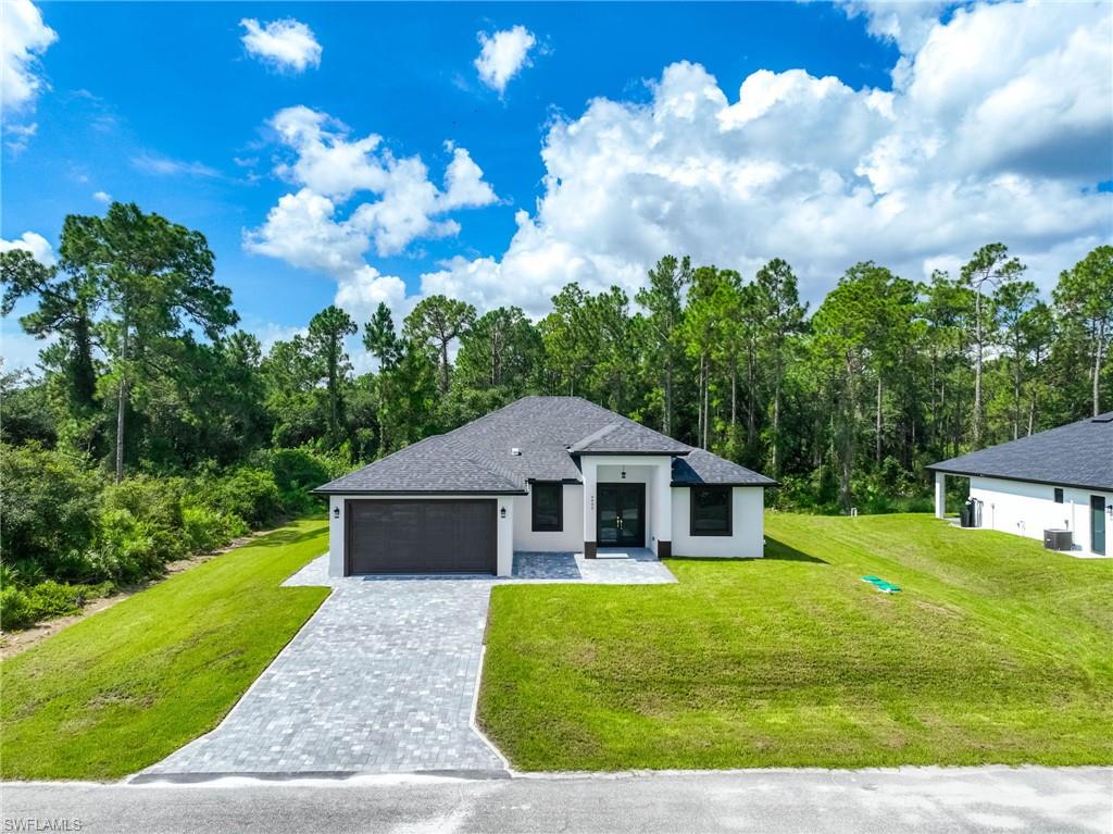 Exclusive New Construction ! Move-In Ready! Welcome to this stunning 4-bedroom, 2-bathroom contemporary home offering 1,772 square feet of luxurious living space. Thoughtfully designed with exceptional custom upgrades throughout, this residence perfectly blends elegance, comfort, and modern Florida living, Step inside to experience soaring tray ceilings, 8-foot interior doors, and beautiful 24” tile flooring extending throughout the home, including the entry and lanai. Impact-resistant doors and windows provide both peace of mind and energy efficiency. The gourmet kitchen features custom cabinetry with granite countertops, stainless steel appliances, and premium finishes that continue into the beautifully designed bathrooms. LED lighting throughout enhances the home’s bright and contemporary ambiance, Spacious two-car garage, Open-concept living and dining areas, High-end custom details throughout, Modern architectural design, Conveniently located near schools, shopping centers, and the airport, this exceptional home offers both luxury and accessibility. Experience the best of Florida living in this brand-new contemporary masterpiece ready for
