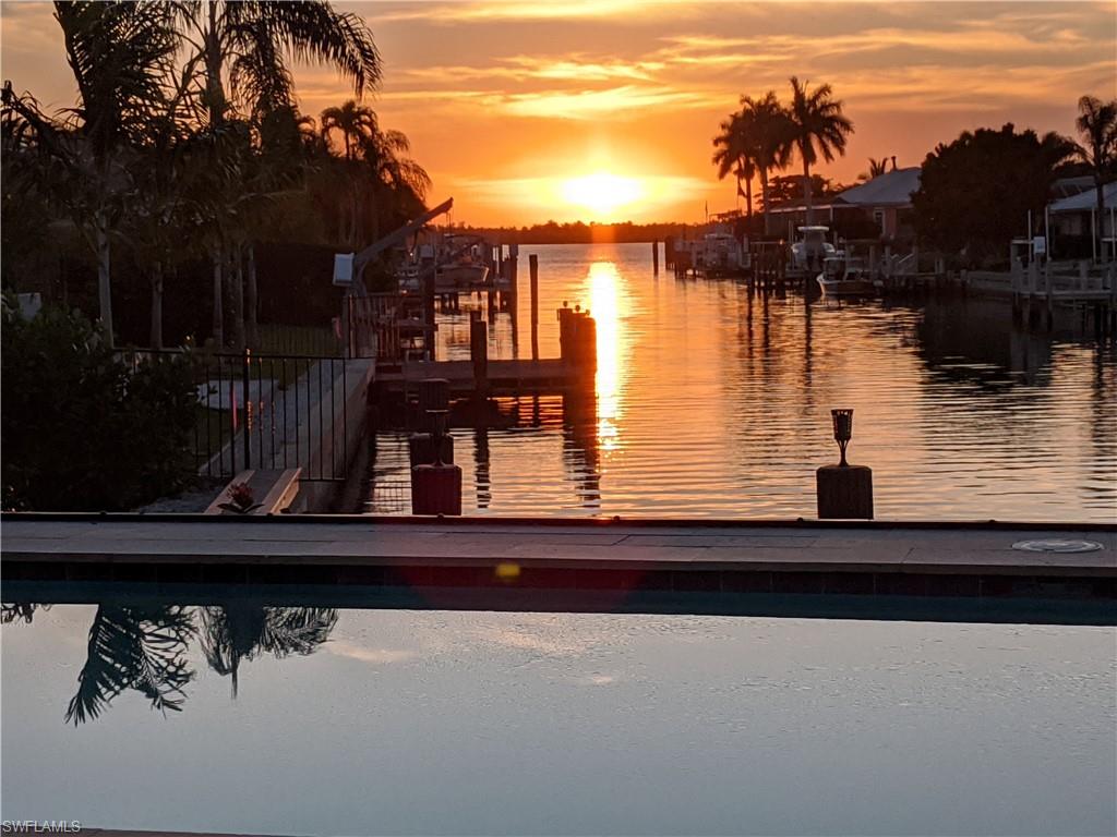 Discover the epitome of coastal living with fast and direct access to the Gulf of Mexico. Located on the North side of the island and a short distance to world famous establishment Snook Inn, close to Rose Marina, The Shops of Olde Marco, Dolphin Tiki, and many more.  Take a quick jaunt by boat to Keewaydin or Isles of Capri. Enjoy every night with breathtaking sunset views in this rarely available gem, nestled in the coveted Old Marco area.  A covered expansive lanai, perfect for relaxation and entertaining. Barbecue area, heated pool, and ample seating to enjoy the serene surroundings with family and friends while soaking in western sunsets and panoramic water views. Step into a world of modern elegance with quality finishes and meticulous attention to detail throughout. Tray ceilings, stunning travertine flooring, and tasteful design elements create a sophisticated ambiance. This impeccable contemporary home seamlessly merges indoor-outdoor living with breathtaking craftsmanship and design. Boasting 3 bedrooms, 3 full bathrooms, including a private guest suite perfect for a In-law suite, caretaker, au pair or what suits your needs and has two separate entrances. This home has high elevaton a no water intrusion from past storms/hurricanes.  A long driveway provides ample parking for guests, which is helpful since there is no overnight street parking on Marco Island. The two-car garage features epoxy flooring for added convenience and style. The exterior of the home is beautifully landscaped, offering a picturesque setting to complement the coastal lifestyle. Dock your vessel with ease and explore the pristine waterways and hidden gems of the coast. Close to beaches, dining, shopping, and recreational amenities. Don't miss the opportunity to own this exceptional coastal retreat in one of Marco Island's most sought-after locations. Schedule a private showing today and embark on a journey of luxury coastal living! Start envisioning your new life in Paradise!