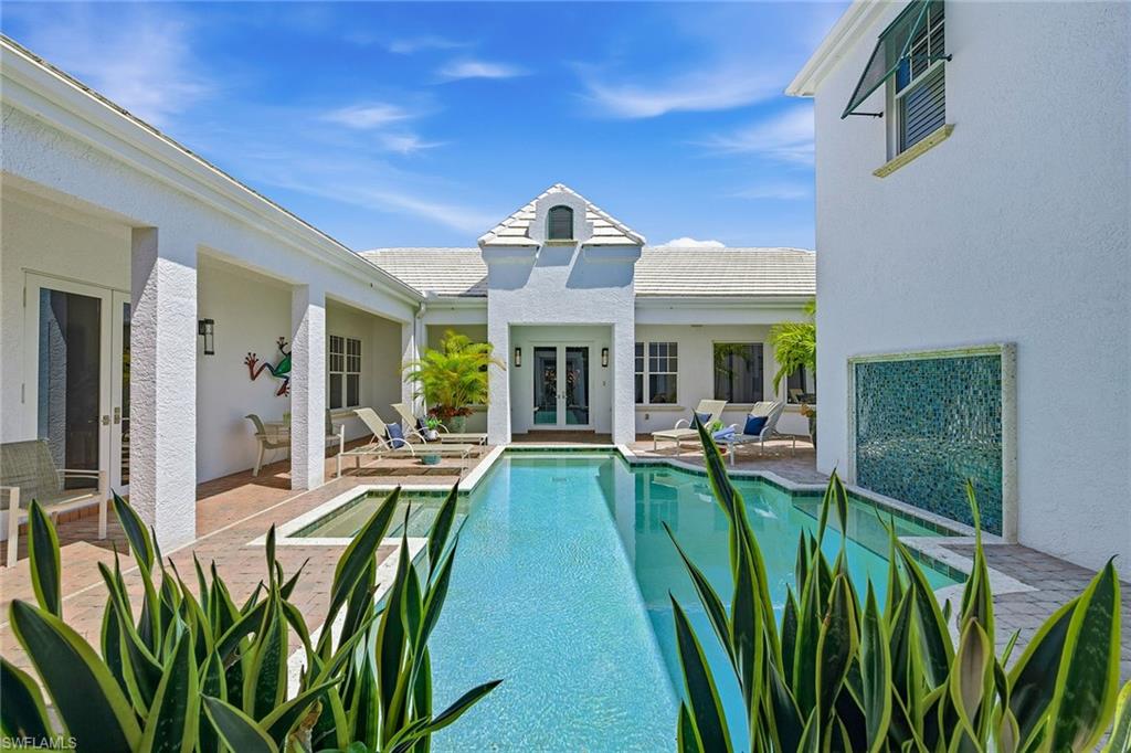 Along a lushly landscaped street in the sought-after Moorings neighborhood, this luxury residence offers an expansive, thoughtfully designed floor plan ideal for everyday living and effortless entertaining. Meticulously maintained and tastefully finished, the home blends timeless elegance with modern comfort. At the heart of the home, a stunning, fully remodeled kitchen serves as a showpiece, featuring dual islands, exquisite quartzite countertops, abundant wine storage, a spacious walk-in pantry and professional-grade appliances with gas cooking. Other recent enhancements further elevate the property, including a 63kw full-home generator, an updated laundry room, and an impressive screened lanai complete with a full summer kitchen, ideal for enjoying Naples indoor-outdoor lifestyle. The home’s private, split-bedroom layout provides ideal separation and comfort. The luxurious owner’s retreat offers a rare dual-bath configuration, each with generous walk-in closets, creating a sanctuary. A privately situated study provides a quiet workspace, while an attached cabana room with a morning bar and full bath offers flexibility for guests or poolside living. A spacious guest suite ensures privacy, while two additional guest bedrooms and a well-appointed bath are upstairs. At the center of it all, a European-inspired courtyard creates a serene focal point, complete with a sparkling south-facing swimming pool, an inviting setting for relaxation or entertaining under the Florida sun. Surrounded by lush mature landscaping enhanced with outdoor lighting, the property also features a 2.5-car garage and a circular drive, adding convenience and curb appeal. In the prestigious Moorings community, residents are just minutes from world-class dining, shopping and cultural venues. The neighborhood also offers access to the private Moorings Beach Park, one of Naples treasured amenities, providing pristine Gulf-front access with parking, facilities and a tranquil coastal setting. This is a rare opportunity to own an exceptional home in one of Naples desirable locations, where space, privacy and lifestyle come together seamlessly.