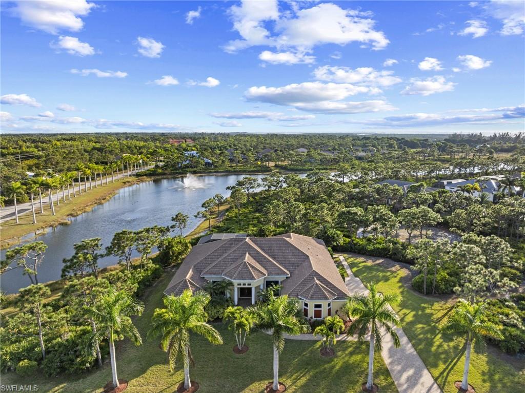 ***NO FLOOD ZONE l ZERO WATER INTRUSION EVER*** Discover a rare offering on Pine Island, an immaculate custom estate set on an expansive 1.2-acre homesite in Calusa Ridge, one of Bokeelia’s most sought-after nature-preserve communities. Elevated on a natural ridge in Flood Zone X (12 to 17 feet above sea level) this property offers both peace of mind and a stunning private setting overlooking a quiet preserve and lake.

Inside, the home feels bright, open, and welcoming with soaring 10 to 12 foot ceilings, abundant natural light, illuminated alcoves for artwork, and luxurious finishes throughout. The main living area includes a formal dining room and a convenient half bath for guests. The spacious kitchen is designed for those who love to cook and gather; it offers solid wood cabinetry, granite counters, a large island with seating, double ovens, stainless steel appliances, and ample space for a dining table and has an adjoining sitting area. A Butler’s pantry with wet bar and pass-through, along with a large laundry room, complete the thoughtful layout.

The home includes two impressive primary suites, each with direct access to the pool area. The main suite feels like a private retreat with an oversized walk-in closet, an additional linen closet, and a spa-inspired bath featuring a jetted stand-alone tub, a generous shower, dual vanities, and a separate WC. Two additional bedrooms each have their own private full bathrooms, offering comfort and convenience. A fourth bedroom works perfectly as an office or den and is located just across the hall from the half bathroom.

A disappearing slider opens to more than 1,000 square feet of fully screened outdoor living space finished with 20/20 super screens and elegant pavers. The heated saltwater pool is ideal for lap swimming and features newer Pentair equipment and night lighting. The outdoor area also includes a full bathroom and a well-appointed kitchen with a JennAir grill, downdraft, bar seating, and a fridge, perfect for relaxed evenings overlooking the lake and its illuminated fountain.

Built in 2014 and exceptionally cared for by its original owner, the home includes a long list of high quality upgrades. It features hurricane-rated windows and doors, a high-end concrete barrel tile roof that creates exceptional energy efficiency, and two new Carrier HVAC systems installed in 2025. The exterior was freshly painted in 2023 and septic tank was pumped in 2026.

Underground utilities, a six-acre community lake with a gazebo, lush tropical landscaping, and a paver driveway add to the appeal. Calusa Ridge offers a quiet, naturally beautiful setting close to marinas, fishing, and waterfront dining. It is located just under two miles from the marina for easy boating access, and **golfers will appreciate that the reopening of the only golf course on Pine Island is just 3 miles away**. This home offers a stunning blend of quality, privacy, and thoughtful design. Your slice of paradise awaits.