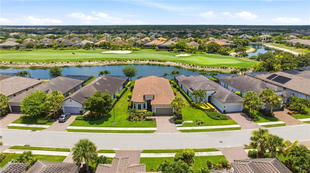 LIVE A VACATION LIFESTYLE IN ESPLANADE! FULL GOLF MEMBERSHIP INCLUDED! 

This immaculate and well maintained “Lazio” is situated on an oversized, premium homesite overlooking the lake and 14th green! Perfectly positioned with southwestern rear exposure lends itself to direct sunset views during the cool winter months and sun over the pool throughout the day. Inside, you will find 3 bedrooms plus den, 3 full baths, and just over 2,300 sq ft of open concept living space. From the moment you walk in the glass front door, you are greeted with rich wood floors, detail moldings with custom cut mirrors, designer window treatments, and two sets of sliding glass doors to the extended covered lanai with outdoor kitchen that can be enclosed by the motorized roll down hurricane screens. Enjoy days around the salt water pool with plenty of deck space for sunbathing. The kitchen is the heart of the home and features raised panel cabinetry with pull out shelves, quartz countertops, and GE Cafe appliances including a GAS cooktop, wall oven, and wine cooler. Other fine appointments include: whole house generator; extended 2 car air conditioned garage (20’x24’) with finished floor & built-in storage cabinets; brand new HVAC (2024); new washer/dryer (2024); custom closet built-ins; Culligan water purification system; in-ceiling speakers powered by Sonos; new carpet in the guest bedrooms; custom shelving & cabinetry in the den; upgraded landscaping with landscape lighting; freshly painted exterior; stacked stone elevation detail; crown molding & wainscoting details; upgraded lights/fans throughout; hurricane impact front door with matching sidelights (with additional roll down hurricane screen); spacious Laundry Room with cabinetry; and more! 

Esplanade Golf & Country Club of North Naples offers a true “Lifestyle Community” with world-class amenities, including a resort pool with cabanas and the popular “Bahama Bar,” tennis, pickleball, bocce, a 14-mile network of bike/walking trails, and an 18-hole private golf course. The impressive 15,000 Sq Ft clubhouse features a restaurant, bar, wine-tasting room, wine lockers, and a Starbucks-style café. Best of all, the property’s landscaping, irrigation, golf membership, and all community amenities are covered under a quarterly fee of just $3,743—no additional fees or memberships required! Don't miss your opportunity to own this exceptional home in one of Naples’ most sought-after communities. Schedule your tour of this stunning home and Esplanade Golf & Country Club today! COMING SOON TO ESPLANADE (2026): Fully renovated and expanded poolside Bahama Bar; expanded outdoor bar at the Barrel House; expanded golf practice range; and an AIR CONDITIONED INDOOR PICKLEBALL COMPLEX with four indoor courts. Special assessment has been PAID IN FULL!