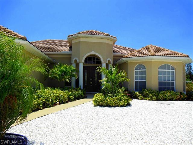Just imagine gorgeous sunsets over a wide, private canal from a meticulously maintained, newer-built home with pool, spa, wraparound composite dock and 10,000lb boat lift. Featuring a Western exposure overlooking intersecting canals on the sailboat side of this quiet section of the Cape you'll find this 3 bedroom plus Den, 2 bath home with more than $100K in updates within the last 4 years. Interior features include tile flooring throughout the entire living area, granite counters, stainless appliances, a large Master suite with two walk-in closets and roman shower. All this and a view that what will delight you all day long. Catch blue crabs in the canal or watch the manatee and shore birds play. Natural breezes from the west keep the pool area cooler than most. The front features stunning wood-inspired entry doors with white granite and black marble landscape stone to make exterior maintenance a snap! Privacy, quality and location define this home - make an appointment to see it today!