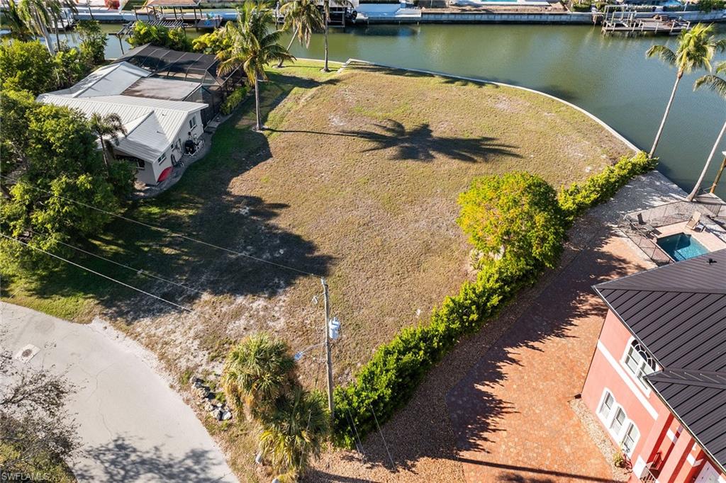 With a seawall completed in 2016, this homesite is ready for your dream home. Located in the desirable, mid-island, Glenview neighborhood, this homesite is set in one of the desired enclaves on Fort Myers Beach. This extraordinary lagoon-front homesite offers a rare opportunity to create a custom waterfront estate on a scale seldom found on the island. Positioned on an over-sized .42-acre parcel spanning more than 18,000 square feet, the property enjoys a striking setting on intersecting waterways, creating an exceptional sense of openness, water presence and long, dynamic views. Randy Lane is recognized for being among the highest elevations on Fort Myers Beach, a desirable characteristic that enhances peace of mind and long-term value. Combined with deep water access, the location is ideal for boating enthusiasts seeking effortless access to the bay and Gulf beyond, while enjoying the calm and beauty of a protected lagoon setting. The generous dimensions of this homesite provide a rare canvas for architectural creativity, allowing for a thoughtfully designed residence that embraces indoor-outdoor living, expansive outdoor entertaining areas and resort-style amenities. A second-story design would unlock beautiful bay views, adding another layer of visual interest and lifestyle appeal while capturing coastal breezes and stunning sunsets. This premier location blends privacy, prestige and proximity to the best of Fort Myers Beach.Whether envisioned as a primary residence or a refined coastal retreat, this exceptional homesite offers the foundation for a one-of-a-kind waterfront lifestyle in one of Southwest Florida’s sought-after settings.