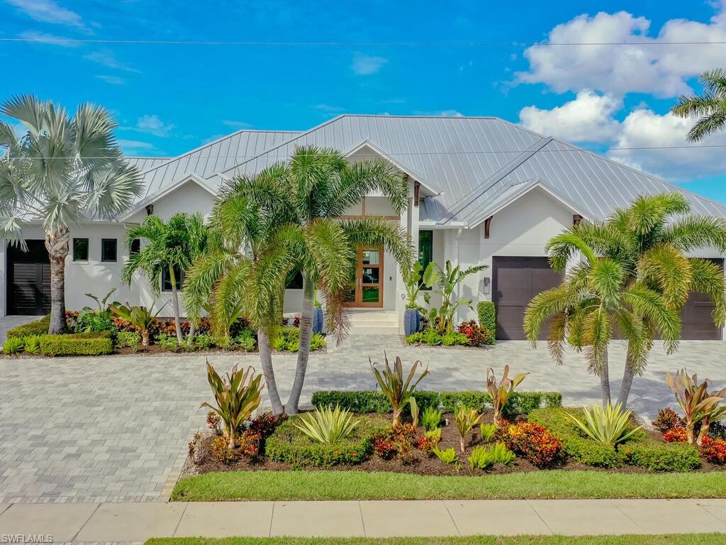 Welcome to paradise, where luxury living meets a vibrant island lifestyle! This stunning property in the sought-after Marco Island Estates area is a true gem, offering everything you need for elegant living and endless outdoor adventures. Experience the expansive great room, crafted for effortless entertaining and relaxation, providing the perfect setting for family gatherings and social events. The outdoor space is equally impressive, featuring a beautifully appointed kitchen where you can dine while overlooking the sparkling saltwater pool. The expansive backyard boasts a large fire pit, ideal for enjoying the cool Gulf breeze in the evenings. With quick access to the Gulf of Mexico, you’ll be out on the water in no time! The dock includes both 10,000 lb and 40,000 lb lifts, ensuring your boats are always ready for adventure. A convenient ramp leads to a small floating dock, making it easy to launch your kayak or paddleboard for a day of exploring the breathtaking 10,000 Islands. This home isn’t just a place to live; it’s a gateway to endless adventures, unforgettable sunsets, and cherished memories with loved ones. Featuring 4 bedrooms and 3 bathrooms, this property provides ample space for families and guests, along with the convenience of parking up to 4 cars in its two garages. Don’t miss your chance to own this incredible property!