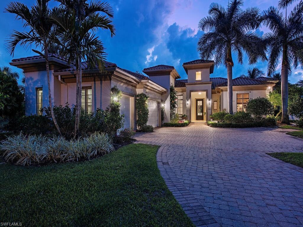 This exceptional custom home is set apart by its location on a cul-de-sac, Premium western exposure lot surrounded by great water views. Built by Gulf Shore Homes, and recently updated with the finest finishes this residence exudes quality! Soft cream marble floors grace the bright entry, dining and living featuring a fireplace and clear views of the beautiful pool area lake beyond. Daily activity centers around the magnificent, new kitchen, with custom cabinetry and Taj Mahal quartzite tops, breakfast, and family area where two walls of impact doors disappear to seamlessly include the outdoor living areas. Two kitchen islands look beyond the interior to the outdoor fireplace, palms, pool, and lake views. Top-of-the-line appliances, pull out shelves, oversized pantry and separate service bar are a few of many upgrades. Rich wide plank unpolished wood floors grace the casual living. Bedrooms are en suite and the generous master provides a restful setting with seating and nearby study. Grey Oaks new resort style pool, exquisite dining, and exceptional Wellness Center have crowned this community, first in class!