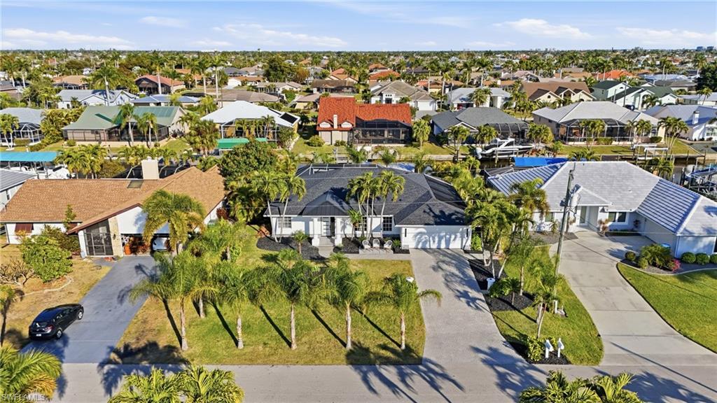 Luxury Waterfront Living | Sailboat Access | Turnkey Gulf Access Retreat

Experience the perfect blend of timeless elegance and effortless waterfront living in this impeccably renovated Gulf access residence. Designed with both luxury and comfort in mind, this exceptional home offers sailboat access with no bridges, placing you just 10 minutes to open water from your private dock, featuring a 10,000-pound boat lift and convenient kayak launch.

Inside, soaring vaulted ceilings and a desirable split-bedroom floor plan create an inviting sense of space and privacy. The stunning chef's kitchen is the heart of the home, showcasing dramatic waterfall quartz countertops, a massive center island, custom cabinetry, and brand-new high-end appliances—perfect for entertaining or everyday living.

Every detail has been thoughtfully curated with elegant, high-end finishes throughout. Offered fully furnished and turnkey, the home is beautifully appointed with sophisticated teak and leather furnishings, allowing you to move in and immediately enjoy the Southwest Florida lifestyle. Never used as a rental, this meticulously maintained residence reflects true pride of ownership.

Step outside to your own private tropical oasis where a heated screened pool, expansive lanai, fully equipped outdoor kitchen, and multiple outdoor seating areas create the ultimate setting for entertaining or relaxing. Professionally landscaped for privacy, the backyard enjoys sought-after sunrise exposure, offering peaceful mornings overlooking the water.

Additional premium features include hurricane protection, a new roof, new HVAC system, a spacious two-car garage, and extensive outdoor living spaces designed to maximize the waterfront lifestyle.

Located just a short boat ride—or an easy bike ride—from the boutiques, waterfront dining, and entertainment of Tarpon Point Marina, this extraordinary property offers the rare opportunity to enjoy luxury, convenience, and direct boating access in one exceptional package.

This is more than a home—it's a turnkey waterfront lifestyle ready to be enjoyed from day one.