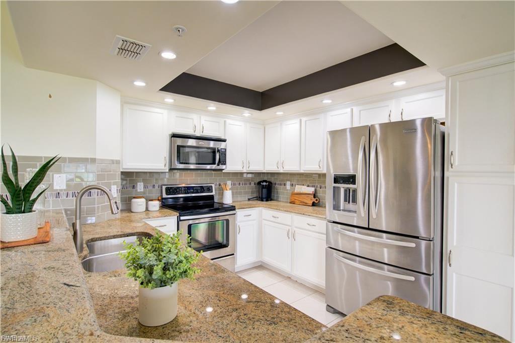 GROUND FLOOR - GARAGE- GOLF COURSE VIEWS This beautifully updated Wedgewood Fountain home at Worthington offers stylish, single level living in a prime location. Expanding your indoor space, the Lucite sliding doors with electric hurricane shutters on the lanai add approximately 200 sqft more of living space. Seamlessly connecting indoor and outdoor living, inside you will enjoy recently installed plantation shutters throughout, granite counters with tile backsplash, upgraded cabinets, recessed lighting, stainless steel appliances and tile flooring in main living areas. Bathrooms feature granite counter tops. In addition, you have a garage and use of nice fully charged ready to go Golf Cart, two sets of clubs, two bicycles and a gas grill. Residents enjoy well maintained grounds, access to golf, tennis and club house. Offering both active lifestyle and luxury. If you want full access to the clubhouse, and Golf membership there is a $500 transfer fee.