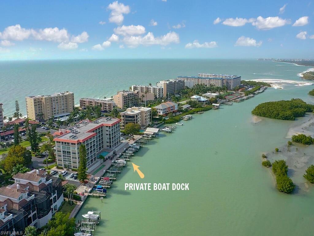Your beach and boating retreat awaits! Located on the 5th floor this unit has one of the most spectacular views in the building, the inside corner allows for expansive views of the bay, mangroves and the gulf beyond. Enjoy the views from your large screened lanai as the sea breeze blows through the sliders of the master bedroom and living room. Enjoy the direct access to the gulf from your boat dock included with this unit or relax on the beach located directly across and easily accessed via the deeded beach access. The unit is tastefully remodeled throughout with wood look tile, granite counter tops, 2018 AC and electric storm shutters. Two bedroom, two bathrooms and a deeded under cover parking space. Sold furnished this condo is ready to move right in.