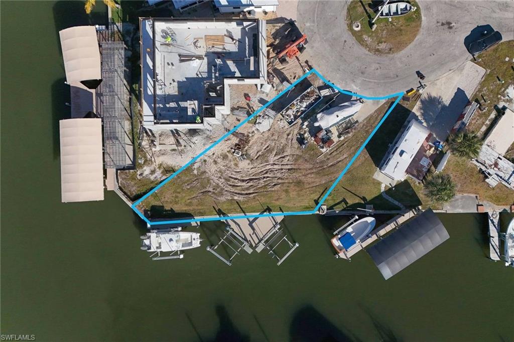 Don't miss this GEM. Located at the end of the canal in the cul-de-sac overlooking the natural mangrove preserve. Over 4,000 sq ft lot with 80ft of seawall to build your custom home or a modular home. The homesite comes with water & sewer along with 3 10,000K boatlifts and composite decking. St James City is golfcart friendly. It also boasts the best worldclass fishing and is just a short boat ride to the outer islands & Fort Myers beach. Now if you really want some space the adjoining lot is also available at 3941 blueberry & now you have over 130ft of waterfront paradise. check out the virtual tour.