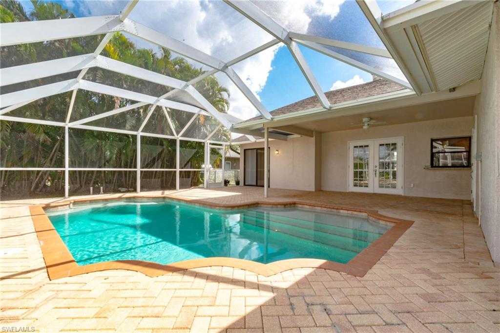 POOL HOUSE JUST RENOVATED!! Centrally located close to Viscaya Pkwy and Del Prado Blvd.  3 bedrooms, 2 bathrooms, tile throughout, sliding doors in the master bedroom to the pool area, and spacious living room. The kitchen offers granite countertops and stainless steel appliances. Conveniently laundry in residence, New A/C, screened pool, and two car garage attached. Close to everything.