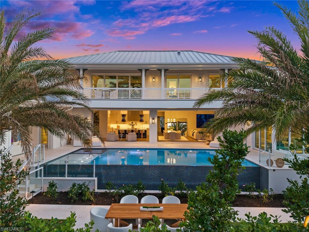 Waterside Builders and MHK Architecture present an unrivaled new construction opportunity on a coveted corner lot in the heart of Park Shore. This thoughtfully designed 5-bedroom + study, 2-story residence spans 5,757 square feet and masterfully utilizes every inch of space - blending elevated luxury with the kind of livable warmth that makes a house feel like home from the moment you arrive.

An inviting front porch welcomes you before entering an open, light-filled floor plan anchored by a stunning gourmet kitchen featuring a 48" range, 60" refrigerator, and a generous island made for gathering. A fully appointed Butler's Kitchen - complete with dishwasher, ice maker, and wine storage - ensures entertaining is effortless at any scale. The living room sets the tone with a 60" gas fireplace and two sets of pocketing sliding glass doors that open to the courtyard style pool/spa. A second floor family room offers the perfect retreat for younger residents or guests and also has sliding glass doors that open to a large covered outdoor living space.

The master suite is a true sanctuary. Wake each morning and slide open the zero-corner sliders to reveal an unobstructed view of your negative-edge pool providing an effortless connection between indoor comfort and outdoor paradise. Outside, 434 square feet of covered living space delivers a fully outfitted outdoor kitchen with a 42" gas grill, under-counter ice maker, and refrigerator, alongside a gas fireplace, fire pit with built-in seating, and elegant glass pool railing, and roll-down shutters and screens.

Additional features reflect the meticulous attention to detail throughout: a whole-home generator, 1,000-gallon propane gas tank, private elevator connecting the garage to both living floors, 2nd floor stacked washer/dryer in addition to the large first floor laundry that is connected to the huge master closet.

Park Shore places you right in the middle of everything Naples has to offer. From world-renowned shopping and dining at Waterside Shops and Venetian Village, private beach access exclusively for residents and the white sands of Naples' top-rated beaches just minutes away. This is Naples luxury living without compromise.