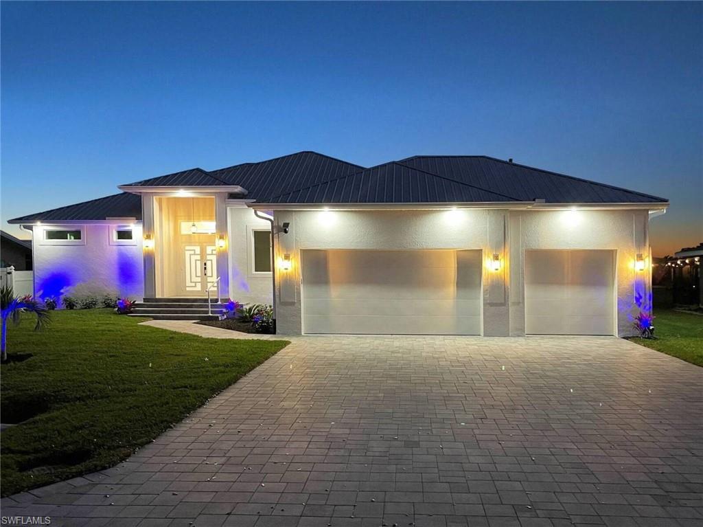 Welcome to this exceptional custom-built new construction home, where contemporary elegance, thoughtful design, and energy-efficient living come together seamlessly.

Ideally situated on a quiet residential street, this prime location offers the perfect balance of privacy and convenience. Enjoy being just minutes from shopping, dining, top-rated schools, downtown Cape Coral, and the beautiful waterfront at Jaycee Park.

This stunning residence features 3 spacious bedrooms plus a versatile den, ideal for a home office, media room, or guest space. The oversized 3-car garage showcases a premium epoxy-coated floor, providing both durability and a sleek, showroom-quality finish.

Step inside and be greeted by soaring ceilings, designer architectural details, and sophisticated RGB LED lighting that create a warm, modern ambiance throughout the home. The gourmet kitchen is a chef’s dream, featuring premium appliances, an induction cooktop, abundant cabinetry, and elegant finishes perfect for entertaining and everyday living.

Built with superior insulation and energy-efficient construction techniques, this home delivers year-round comfort while helping keep utility costs remarkably low.

The luxurious owner’s suite serves as a private retreat, offering direct access to the outdoor living area and garden. A secondary bedroom also enjoys private garden access, creating a seamless connection between indoor and outdoor spaces