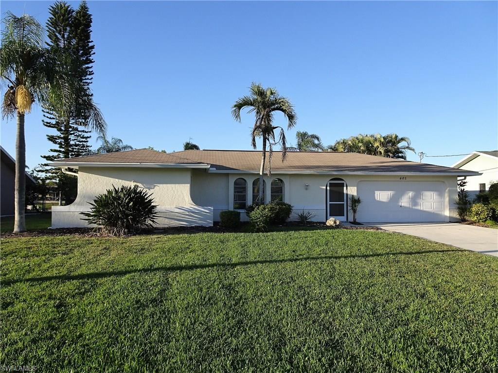Enjoy this beautiful, updated pool home on an extra wide (140’) gulf access canal. Park your boat right in your own backyard on your private 10k lb boat lift with captain’s walk. This freshly painted home has updated bathrooms and an open kitchen with upgraded Corian counter-tops. The lawn is well maintained, and new seamless gutters were added last year. The custom pool and spa and large covered lanai are accessed by pocket sliding glass doors from the master bedroom and living room. The plumbing has all been updated with CPVC. The city water and sewer assessments are paid in full.  This home is a split floor plan, so the guest and master bedroom are on opposite sides of the house for privacy.  The location couldn't be more convenient to shopping, dining and entertainment. Just a short distance to Veterans Parkway for easy access to Fort Myers. This home is ready to move in and start entertaining friends and family!