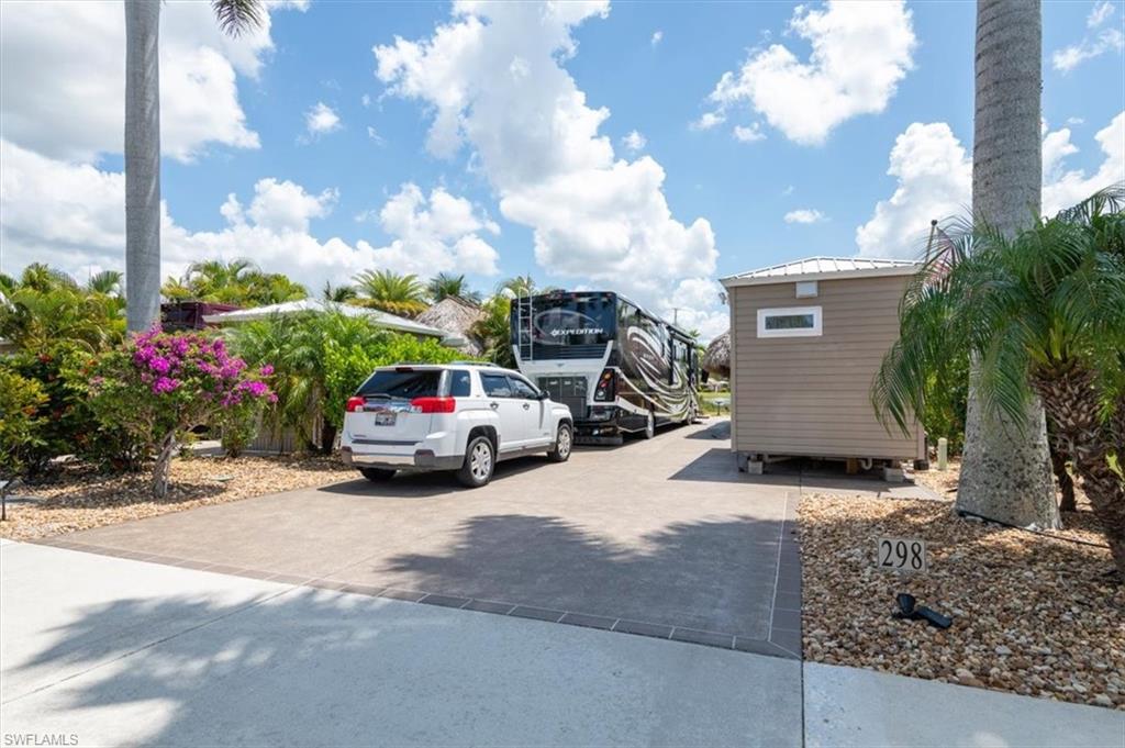 Welcome to Lot 298 in Cypress Trail RV Resort, a beautiful 35’ x 90’ Class A only lakefront lot located on peaceful Sunrise Lake. Enjoy spectacular sunrises, moonrises, all-day water views, and the calming glow of the lighted fountain in the evening.

The improved 8’ x 15’ shed offers exceptional function and comfort, featuring an LG Smart stackable washer and dryer, a stunning 3’ x 5’ tiled shower with bench, toilet, oversized stainless-steel sink, quartz countertop, abundant cabinetry, upgraded vinyl plank flooring, dimmable under- and over-cabinet lighting, mini-split A/C, upgraded insulation, on-demand hot water heater, and generous overhead storage.

Outdoor living shines under the spacious 13’ x 30’ tiki, re-thatched in 2023 and equipped with a fan and 55” Smart TV. The raised paver patio, added in summer 2025, provides an elevated space to relax and stay high and dry during Florida rain showers. Beautiful landscaping and a sprinkler system complete the setting.

Located on quiet Marshmallow Trail, this lot offers a peaceful, off-the-beaten-path feel while still being part of Cypress Trail’s vibrant resort lifestyle. Enjoy nature preserves, resort amenities, community activities, and the warmth of Southwest Florida living.

Bank financing is available, and the owners are also willing to consider owner financing.