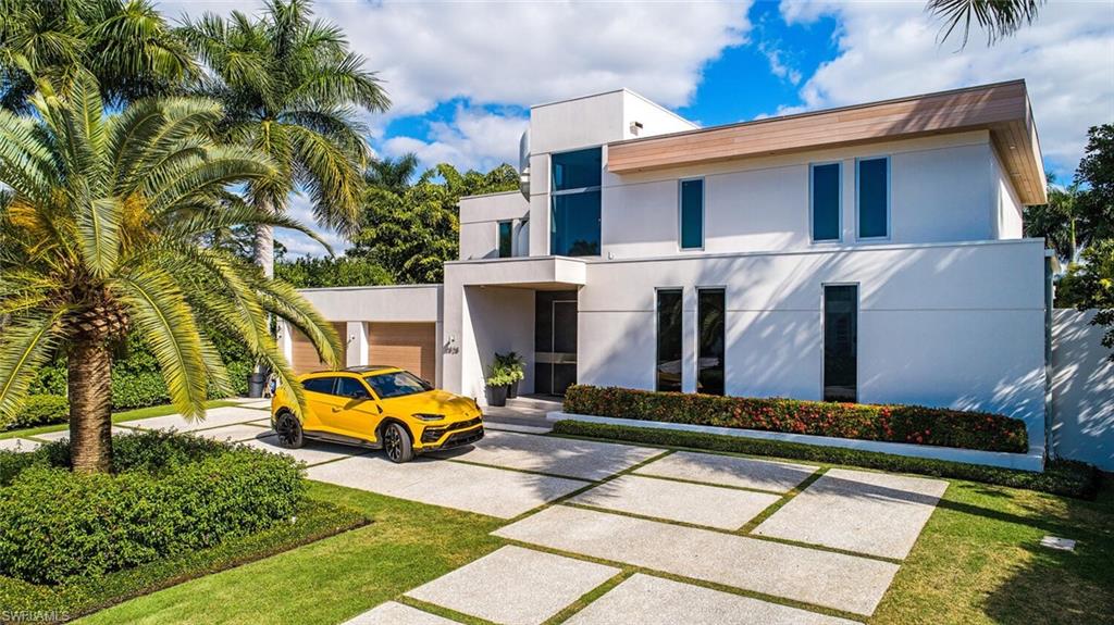 H4293  Unparalleled luxury and architectural style await in this spectacular Naples home that showcases panoramic golf course views. Two-story windows frame the captivating outlook from the 4,192sqft layout where you will find a seamless blend of Californian and European design. There are 4 beds, 4 full baths, and 1 half bath along with a den and a selection of living spaces both inside and out. An open gourmet kitchen with premium appliances awaits plus there’s even a full outdoor Viking kitchen for hosting guests. On cool evenings, you can gather around the outdoor gas fireplace, while throughout the whole year the 44ft double infinity-edge lap pool, spa, and deck promise endless hours of fun. As if that wasn’t already impressive enough, there is a show-stopping 420ft rooftop lounge on the third floor with 360-degree views. This modern masterpiece is 1 of just 9 homes facing the golf course on Crayton Road in the Moorings and is only moments from beaches, golf courses, shopping, and downtown Naples.