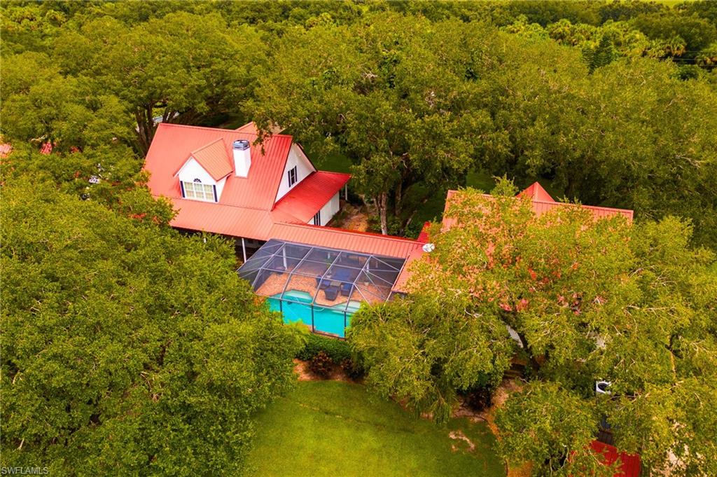 *Recently reduced by $20,000. Seller is motivated and will consider all offers from qualified buyers.*

Luxury meets country charm within this Exceptional 3.02-Acre gated estate in LaBelle, Florida!
Welcome to this rare multi-residence property offering over 5000 Sq ft of living space across the main home, guest house, and garage apartment. The two-story main home features cathedral ceilings, a beautiful eat in kitchen with stainless steel appliances and a stunning floor to ceiling fireplace. Eating dinner in the formal dining room with the beautiful views from the surrounding windows will make family dinners unforgettable. Step into a breathtaking master suite designed for both comfort and style. This spacious retreat features a private bathroom with a separate soaking tub and shower, custom-designed closet with ample storage, built-ins, and useful finishes to keep your wardrobe organized and accessible. The suite also boasts a dual-sided fireplace, thoughtfully engineered to open to both the bedroom and the living room, creating a warm, inviting atmosphere and a seamless flow between spaces. The 2 story Guest house features a full kitchen, large family room, 2 bedrooms and downstairs bath. The extra apartment provides 1 bedroom, 1 bath, and a full kitchen above a 3-car garage with workshop/gym. Enjoy resort-style outdoor living with a saltwater pool, triple waterfall, and screened lanai connecting to the main house with a paver walk way. Nestled on the property is a charming shed-style building, perfect as a home office, creative studio, or “she shed.” Its cozy yet functional layout offers a private retreat, ideal for focused work, hobbies, or quiet relaxation. With its quaint design and versatile space, it adds both character and utility to the property, providing a peaceful escape right in your backyard. The property is fully fenced with dual electric gates, surrounded by beautiful mature oak trees, and includes a 3 bay pole barn with separate areas for different animals near by. The large fenced in side yard is suitable for horses. Perfect for multi-generational living, entertaining, or income potential, this estate combines privacy, luxury, and versatility in one of LaBelle’s most desirable Communities "The Ranchettes"!
