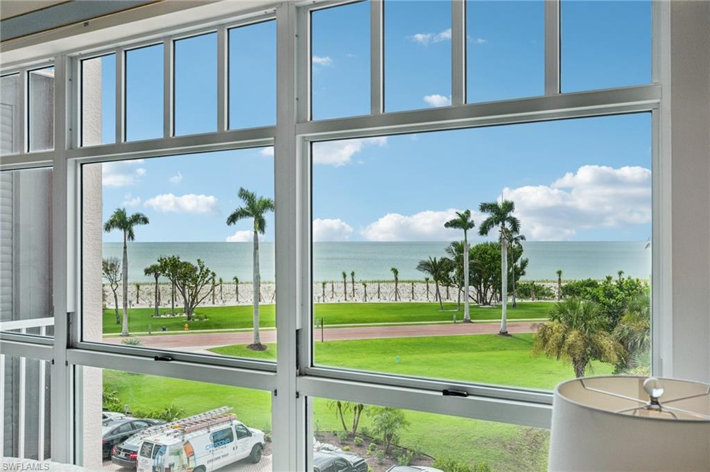 Perfectly positioned to capture the best of both worlds, this 3-bed, 2-bath residence at Barefoot Beach Club offers sweeping, unchanging Gulf views paired with tranquil Bay vistas—delivering a dual-waterfront perspective few properties can match. Just steps from the sand, the beach becomes an effortless extension of daily life. Light-filled and impeccably maintained, the interior unfolds across a thoughtfully designed split floor plan that balances openness with privacy. The main living areas are oriented to the water, drawing your eye outward, while a screened lanai invites in the sound of the surf and showcases breathtaking sunsets over the Gulf of Mexico. The kitchen is bright and functional, featuring white cabinetry, generous storage, and a breakfast bar for casual dining. Tucked along the waterfront, the primary suite serves as a private retreat with stunning Gulf views, direct lanai access, a walk-in closet, and a spacious ensuite bath with dual vanities, a glass-enclosed shower, and a separate soaking tub. Two guest bedrooms are positioned at the front of the residence, offering comfort and separation for family and visitors. Equally appealing as a move-in-ready coastal escape or a canvas for a custom reimagination, the residence also includes impact glass and hurricane shutters for added peace of mind. Residents of Barefoot Beach Club enjoy a gated, amenity-rich setting with access to miles of pristine shoreline, resort-style pools and spas, a newly updated clubhouse with fitness center, and on-site management. Optional membership to the Club at Barefoot enhances the lifestyle further with tennis, dining, and full beach service. Ideally located just minutes from Mercato, Waterside Shops, and convenient access to Southwest Florida International Airport, this is coastal living with a rare vantage point—where Gulf sunsets and bayfront serenity come together in one exceptional offering.