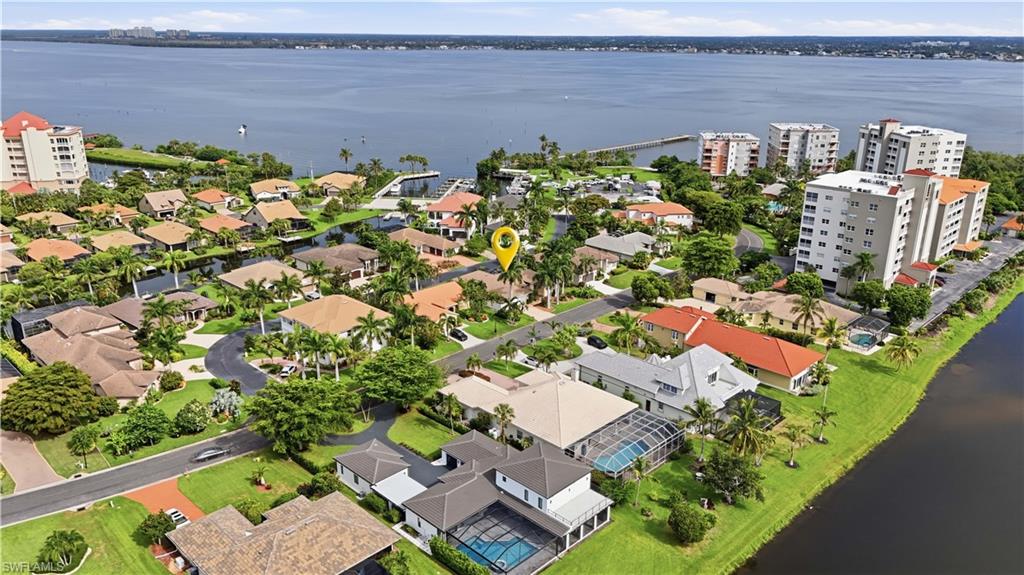 Where everyday begins with the possibility of a day on the water, welcome to a true boating community with direct Gulf access! Upon entry you are greeted with tall ceilings and plenty of windows that make for a sun filled space, cooled with new A/C! This home is wrapped with lush landscaping and surrounded by beautiful homes, making for incredible luxury tropical views out of every window! Ideal split floor plan with the Primary bedroom to the right and guest rooms off to the left past the kitchen. New updates include Kitchen Appliances, Washer and Dryer,  Impact Garage Door, lanai screen, gutters, irrigation pump and garbage disposal.  Enjoy the best of the Florida lifestyle nights with new Spa and Fire pit. Plenty of covered outdoor space upgraded with sun shades. Outdoor half bath, great for entertaining! Experience an exceptional lifestyle in this amenity-rich community, thoughtfully designed for both relaxation and recreation. Residents enjoy access to two heated swimming pools, two tennis courts, a private beach and riverside park, with an impressive 600-foot fishing pier overlooking the river. Boating enthusiasts will appreciate the exclusive 36-slip marina, Peppertree Pointe Marina at Water's Edge, accommodating vessels up to 35ft feet, along with convenient trailer storage and a private boat launch. From the marina, enjoy just 15 minutes to the sparkling Gulf waters and the world-renowned shores of Sanibel Island and Captiva Island. Adding to the charm, the community hosts monthly waterfront dinner gatherings, creating a welcoming atmosphere to meet and greet your neighbors! Waste no time, let's get you and your toys under the same roof and start living the dream south west Florida lifestyle!