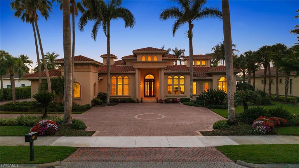 TRANSFERABLE GOLF MEMBERSHIP AVAILABLE! Skip the waitlist and pay only a transfer fee! Ideally situated in the prestigious community of Quail West, this impressive residence offers a thoughtful floor plan complemented by expansive outdoor living spaces including a screened lanai and spectacular golf and sunset views. The luxurious primary suite is uniquely designed with dual en suite bathrooms connected by a shared sitting area creating a tranquil retreat of privacy and comfort. Three additional guest suites offer plenty of space for visitors too. Perfect for entertaining, the open-concept great room flows seamlessly into the chef-inspired kitchen, which features an oversized island, breakfast bar, dual prep sinks, and a walk-in butler’s pantry complete with a beverage refrigerator. From terrazzo flooring and tray ceilings to a cozy fireplace and dramatic floor-to-ceiling windows, every detail of this home speaks of refined elegance. The screened lanai includes a covered seating area with an outdoor kitchen, and the custom pool—with integrated spa and sun shelf—is strategically positioned to maximize sun throughout the day. The spacious three-car garage provides ample room for vehicles, a golf cart, and all your Florida lifestyle essentials.