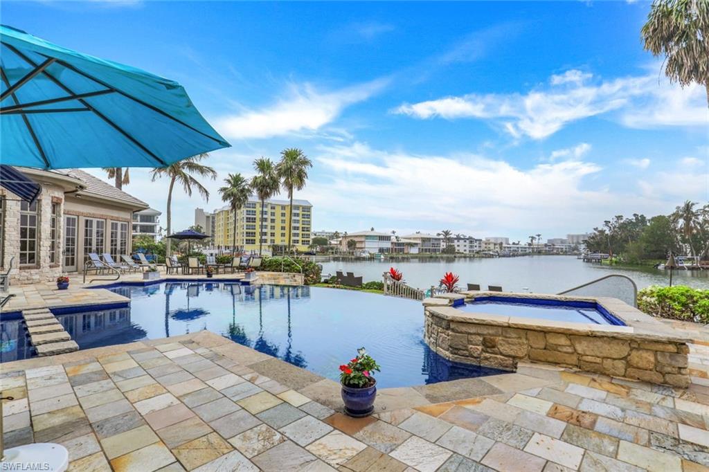 This stunning bayfront estate spans over 5,300 square feet and offers a luxurious & spacious living experience. Situated on a sprawling lot with over 180 feet of water frontage, the property includes a boat dock with lift for easy access to the Gulf. Upon entering the impressive two-story foyer, you are greeted by an elegant & sophisticated interior. The formal living room & dining room provide a perfect space for hosting guests, while the cozy family room & eat-in kitchen with top-of-the-line appliances and generous counter space offer a more casual atmosphere for everyday living. The house also features an office & a den, providing ample space for work or relaxation. A spacious first-floor primary suite & 2 guest bedrooms, each with their own en-suite bathrooms & balconies overlooking the bay, provide breathtaking views of the water & surrounding landscape. Additional features of this magnificent property include a sparkling pool & spa, powder room & full pool bath for added convenience, 2 laundry rooms and a 5 car garage. A luxurious & peaceful retreat, with plenty of space for hosting large gatherings both inside & out while enjoying the natural beauty of the surrounding area.