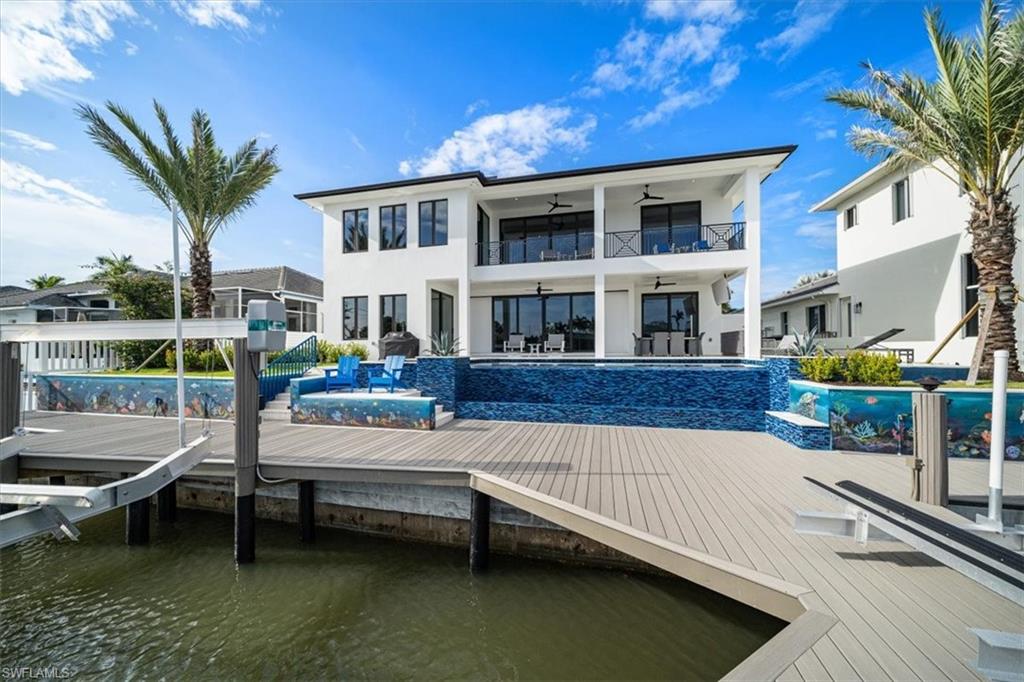 Completed with the finest of builder-quality finishes, this brand new custom home built in Conners offers peaceful water views. Situated on a split-design floor plan, the home is spread over 4,674 square feet, with 4 large bedrooms plus a den and 3.5 bathrooms. Complete with the latest upgrades, finishes, and technology, the property features impressive onyx and quartz counter tops and a large island kitchen with stainless steel appliances and beautiful white cabinetry, pristine wood and tile flooring throughout, wood detailed ceilings, details and accents throughout, a master suite with his/her walk-in closets and gorgeous bathroom with a huge walk-in shower, tub, raised vanities, plenty of space for entertainment, a oversized 2-car garage, & much more. Other notables include led lighting, a dramatic two story foyer, stainless steel railings, state of the art McIntosh sound system, metal roof, security cameras. The lanai offers shell stone decking featuring ample space for entertaining, a large infinity pool with spa, an oversized boat dock/lift & lush landscaping. This home is within distance to award winning beaches, shopping, restaurants, golf courses, The Ritz Carlton & more!