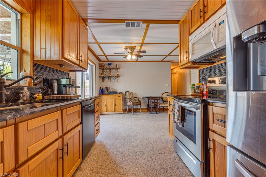 BACK ON THE MARKET!  What a great opportunity to own property WITHOUT dealing with an HOA/Condo Association and associated dues or fees! And it's only 4 miles to downtown Naples! This is a very nice home with a private pool.  A pool cage can be added by the buyer and you will love the lanai and pool lighting. Another great feature is the completely fenced in back yard so there is plenty of room for your pets to run. There is even room for a small garden on one side of the home.  This home has had many upgrades including electrical, plumbing, and roof that have been installed since Irma.  The updated kitchen features hard surface counter and custom made cypress cabinets that are simply gorgeous. The bedrooms are roomy enough for queen beds and the main bedroom has an ensuite bath that can also be used as a pool  bathroom if you choose. You really cannot let this one pass you by.