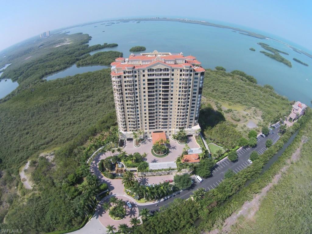 A LUXURIOUS GRAND ESTATE PENTHOUSE! Creatively designed by Beasley & Henley Interiors as the developer's model, La Scala 1903 is magnificent and elegant yet appealingly livable, a 6,720 s.f. (7,990 total) waterfront Sky Home on one level. 5 beds, 6.5 baths, Grand Salon with gas fireplace, formal Dining Room, Family Room with dining, large luxury Kitchen, Den. Breathtaking water views. Crisp blend of rich wood tones, warm stone, plush fabrics and textures. Memorably contrasting living spaces. Appealingly neutral colors with cream, caramel, chocolate and pale golden yellows that soak up sunsets. Wood-floored hallways have a warm and casual feel. 11 feet 8 inch ceilings, huge picture windows, floor-to-ceiling glass sliders, custom built-ins, enhanced ceilings, artistic ironwork, commissioned art, stone counter tops, imported cabinetry, 4 a/c zones, 2 water heaters. Private 2-car garage with large air-conditioned storage room. A stunning showcase penthouse for a discerning buyer, in Bonita's finest boutique luxury tower. Listing agents will provide a one-year home warranty for the buyer. SEE COMPREHENSIVE ATTACHMENTS