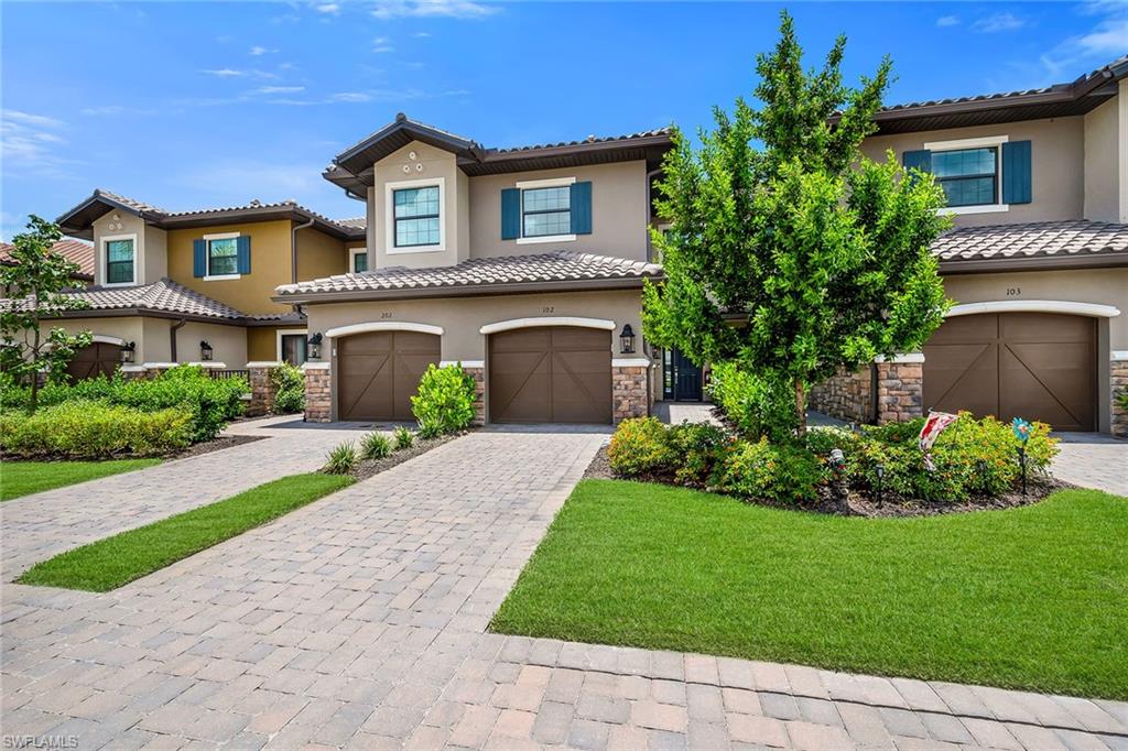 Wake up to tranquil lake views and enjoy the peaceful backdrop from this beautifully appointed residence, where elegant interiors and effortless indoor-outdoor living create an inviting coastal retreat. Filled with natural light, this thoughtfully designed home offers a desirable open-concept layout that seamlessly connects the living, dining, and kitchen areas, making it ideal for both everyday living and entertaining. This two-bedroom, two-bathroom residence with a one-car garage showcases stylish vinyl flooring throughout and a screened patio overlooking the water, providing the perfect setting to relax with your morning coffee or unwind at the end of the day. The spacious living room features a tray ceiling, custom built-ins, an electric fireplace, and pocketing sliding glass doors that open to the lanai, allowing the beautiful lake views to become part of your everyday experience.  The well-appointed kitchen features a pantry, an island with seating, and a suite of modern appliances, including a 2025 dishwasher and 2024 microwave, refrigerator with freezer and icemaker, and electric range with cooktop. The primary suite is a peaceful sanctuary filled with bright natural light and picturesque lake views. The luxurious en-suite bath is designed for comfort with dual sinks, a glass walk-in shower, an enclosed water closet, and a spacious walk-in closet. The guest bedroom offers exceptional privacy with convenient access to an en-suite and hall bathroom featuring a shower/tub combination, making it equally comfortable for family or visitors. A dedicated laundry area includes a newer GE washer and dryer, adding everyday convenience to this well-designed home. With its scenic waterfront setting, inviting open floor plan, tasteful finishes, and desirable features throughout, this residence presents an exceptional opportunity to enjoy the relaxed Southwest Florida lifestyle in comfort and style. Residents of Esplanade by the Islands enjoy an exceptional resort-inspired lifestyle with world-class amenities, including a grand clubhouse, resort-style pool and spa, Bahama Bar, fitness center, wellness spa, tennis, pickleball, bocce, dog park, walking trails, and a full calendar of social events and activities. Ideally located near the shopping, dining, and entertainment of downtown Naples and the white-sand beaches of the Gulf, this vibrant community offers the perfect blend of luxury, recreation, and everyday convenience.
