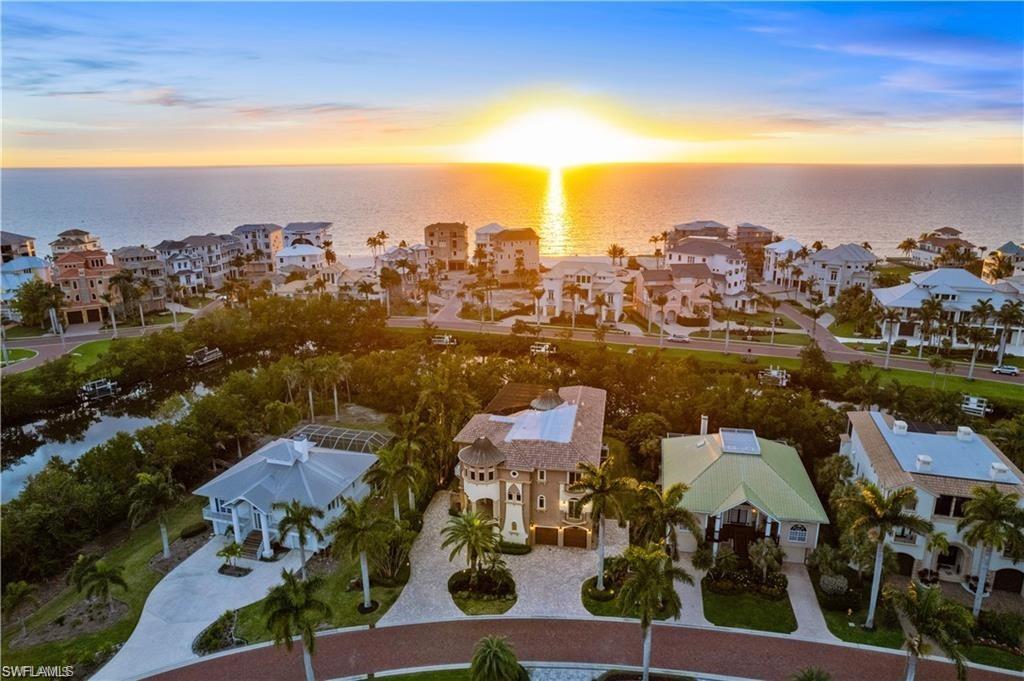 Beautiful Gulf-access home perfectly located in the double-gated Southport on the Bay in North Naples’ premier community of “Barefoot Beach”. This estate is a beach & boaters’ delight with deeded beach access a short walk away & direct Gulf-access only 10 minutes from your boat dock with dual lifts. Offers coveted Western exposure for magnificent sunsets over the ELEVATED pool/spa. This fortress has 4 beds+den/4.5 baths, a NEW TILE ROOF IN 2024 & ALL IMPACT GLASS WINDOWS. The main level offers an open floor plan, wet bar with stand-alone ice maker/wine cooler & zero corner sliders leading to the expansive screened-in lanai with summer kitchen. Chef’s kitchen is perfect for entertaining & offers high-end appliances including Sub-Zero fridge, Thermador oven, 2 Bosch dishwashers & a large butler’s pantry. 3rd level includes a spacious primary suite with a private balcony overlooking the pool, dual closets & spa-like bathroom with a wraparound shower. The OPTIONAL in-community "Club at Barefoot" offers tennis, 2 restaurants, beachside food/bev/chair service & more. Nearby to fine dining & easy access to RSW Airport, Mercato & Waterside Shops. Only 15 miles to Naples 5th Ave.