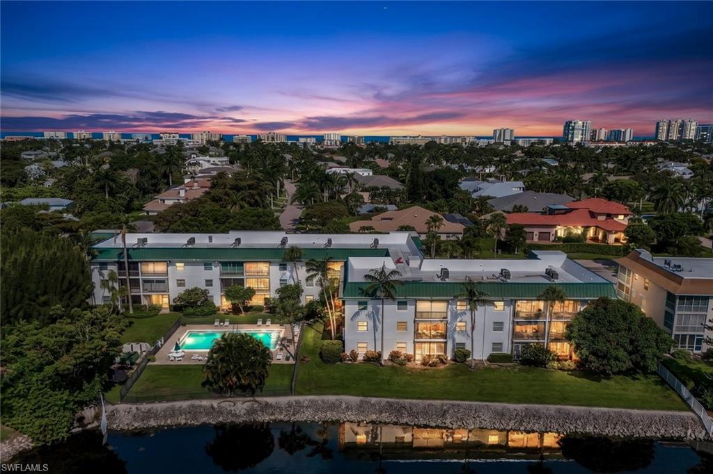 The perfect Naples getaway or home. Enjoy this first floor, updated, end unit residence with unobstructed lake front views. Tile flooring throughout, updated warm wood cabinetry, countertops, sinks and fixtures in the kitchen and baths. Impact resistant windows. Peaceful screened lanai with a sparkling lake with fountain view. Chateau Suzanne features a beautiful large saltwater pool and sitting area, on the lake. Recent roof replacement (2025).Situated in "The Moorings" neighborhood with private beach access membership available. About one mile to the Gulf beaches, minutes to downtown Naples, Villages of Venetian Bay and the Waterside Shops for world class dining and shopping. Seller is offering the property furnished with detailed inventory. Water heater and AC both replaced late 2020. Storage closet is on the 2nd floor. Bike storage is found at both ends of the building, car wash at the south side. Rental opportunities are 12 x per year with a 30 day minimum.